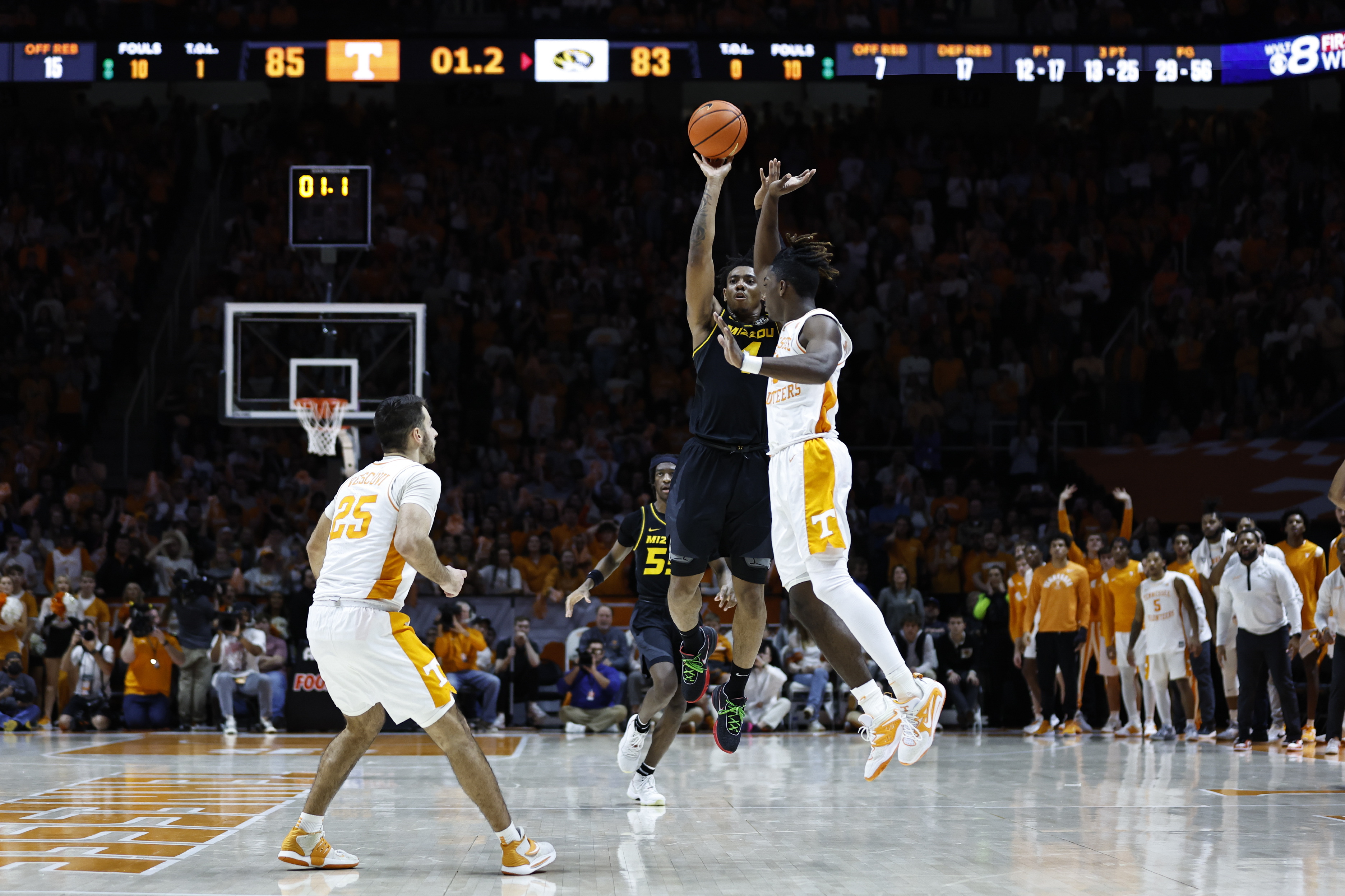 Missouri guard DeAndre Gholston (4) takes a last-second 3-point shot over Tennessee guard Jahmai Mashack, right, during the second half of an NCAA college basketball game Saturday, Feb. 11, 2023, in Knoxville, Tenn. 