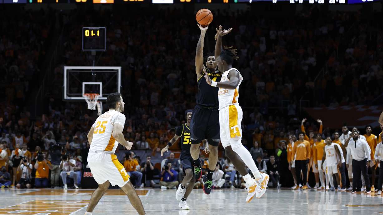Missouri guard DeAndre Gholston (4) takes a last-second 3-point shot over Tennessee guard Jahmai Mashack, right, during the second half of an NCAA college basketball game Saturday, Feb. 11, 2023, in Knoxville, Tenn.
