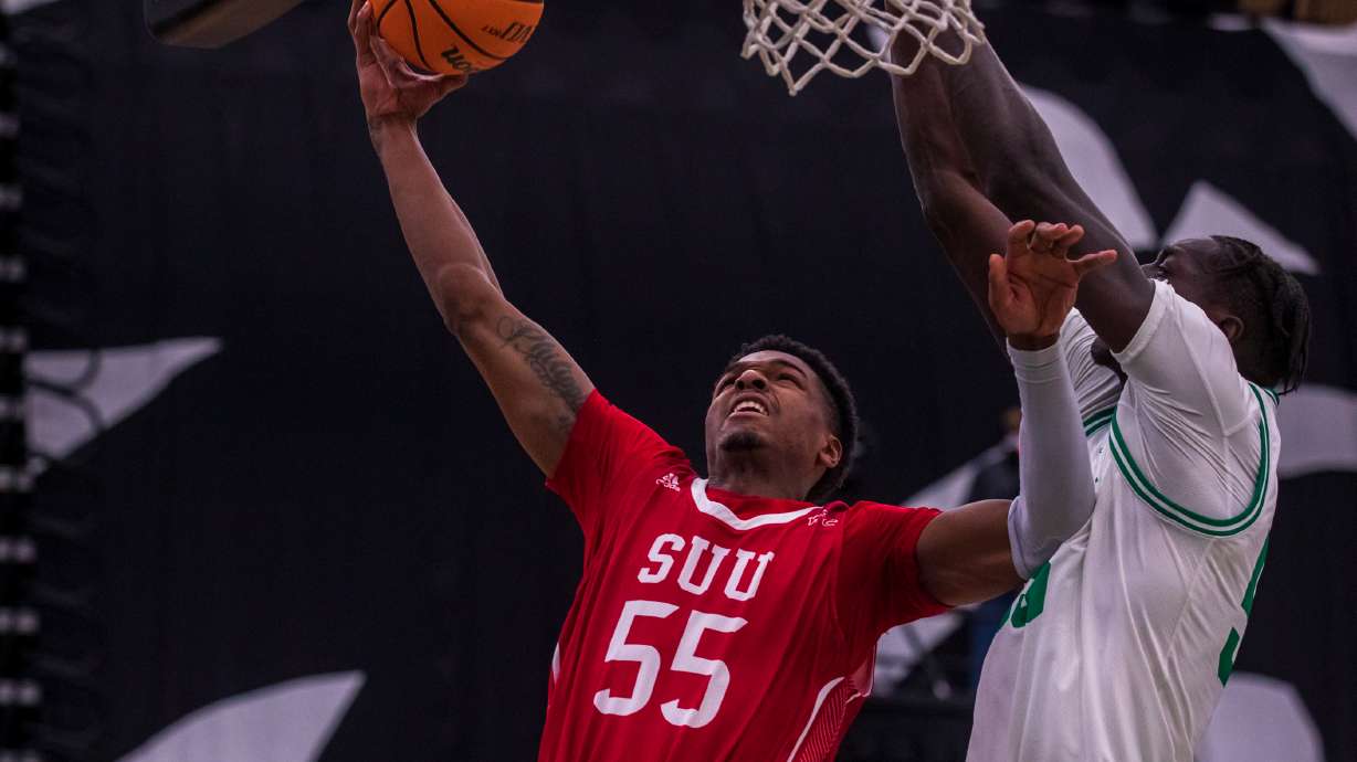 Southern Utah University guard Tevian Jones drives in for a layup attempt against Utah Valley center Aziz Bandaogo during a matchup between UVU and SUU at the UCCU Center in Orem on Saturday, Feb. 11, 2023.