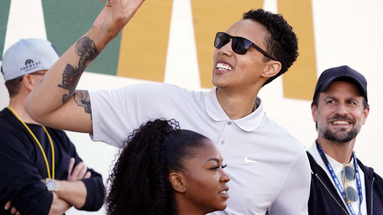American professional basketball player Brittney Griner acknowledges fans as she watches on the 16th hole during the third round of the Phoenix Open golf tournament, Saturday, Feb. 11, 2023, in Scottsdale, Ariz.