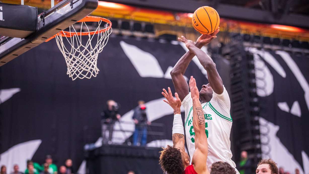 Utah Valley center Aziz Bandaogo shoots over Southern Utah guard Dee Barnes during a matchup between UVU and SUU at the UCCU Center in Orem on Saturday, Feb. 11, 2023.