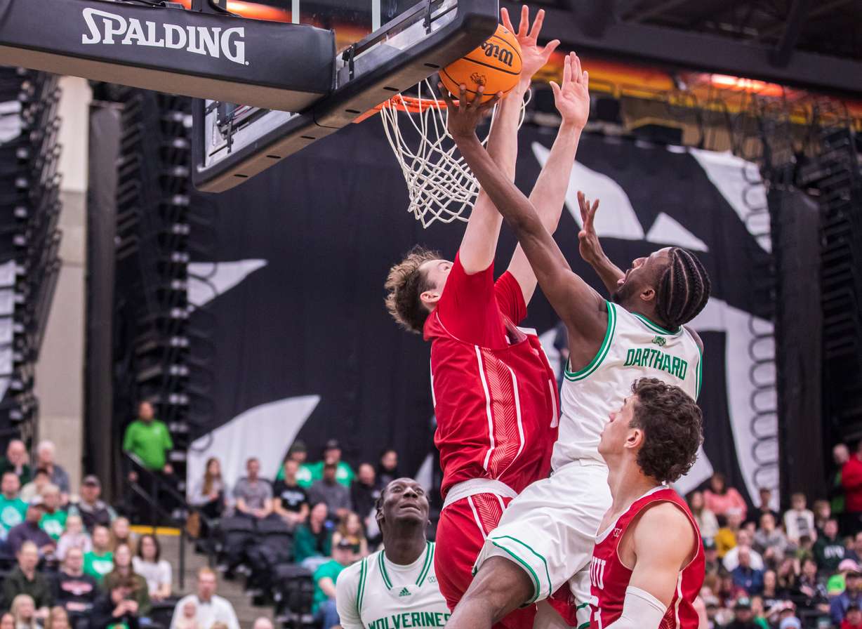 Utah Valley guard Le'Tre Darthard drives in for a layup attempt over Southern Utah University center Jason Spurgin during a game between UVU and SUU at the UCCU Center in Orem on Saturday. Feb. 11, 2023.