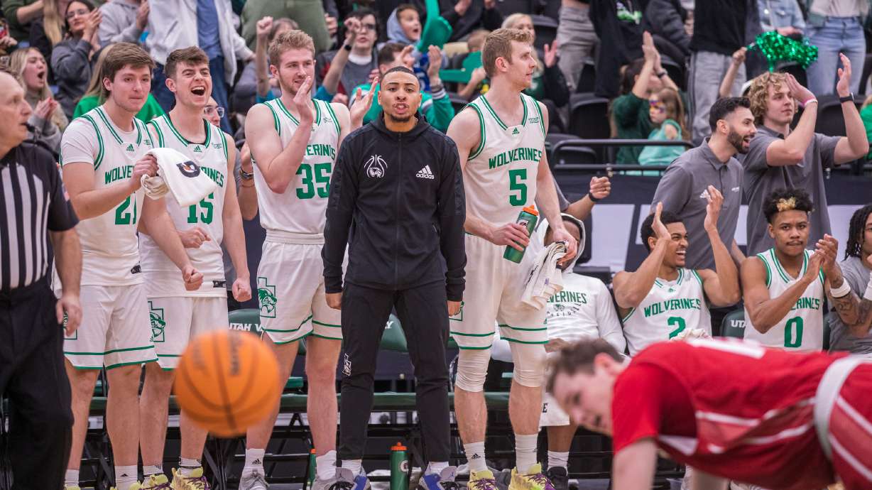 The Utah Valley men's basketball bench celebrate after UVU guard Tahj Small scores a late bucket to extend the Wolverines' lead late in a game against Southern Utah University at the UCCU Center in Orem on Saturday, Feb. 11, 2023.