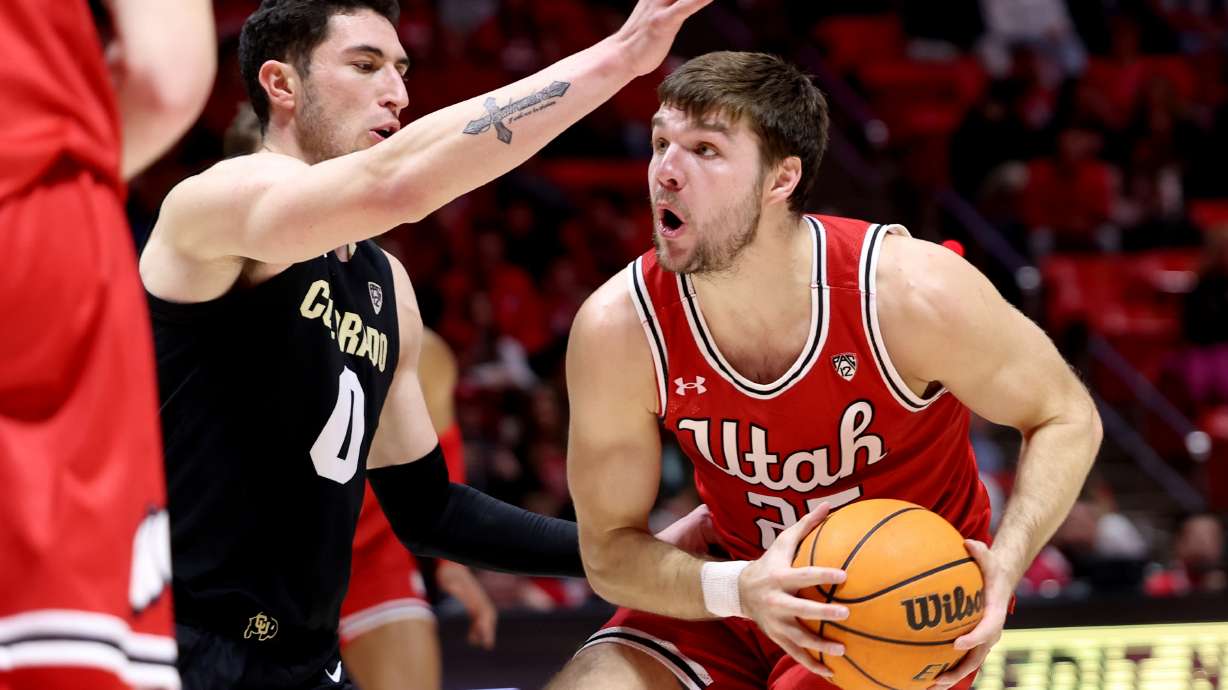 Utah Utes guard Rollie Worster (25) drives on Colorado Buffaloes guard Luke O'Brien (0) as Utah and Colorado play in the Huntsman Center at the University of Utah in Salt Lake City on Saturday, Feb. 11, 2023.