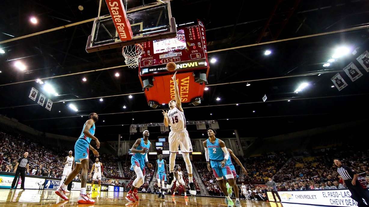 FILE - New Mexico State's Ivan Aurrecoechea shoots against New Mexico during an NCAA college basketball game Nov. 21, 2019, in Las Cruces, N.M. New Mexico State indefinitely suspended its men's basketball program Friday night, Feb. 10, 2023. The school also placed first-year coach Greg Heiar and his staff on administrative leave for what it said were violations of university policy.