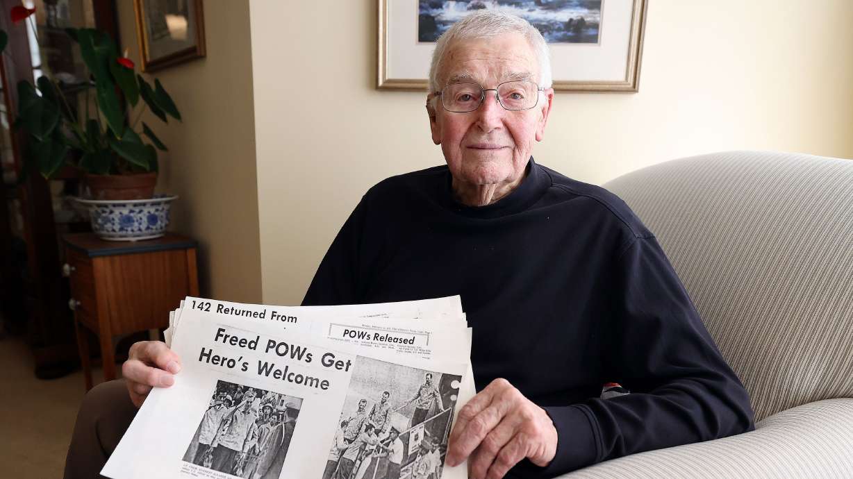 Retired Air Force Maj. James Marrott, who flew released Vietnam prisoners of war to safety in 1973, poses for a portrait with a stack of old photocopied newspaper clippings about him at his home at Sunrise at Holladay in Millcreek on Jan. 23.