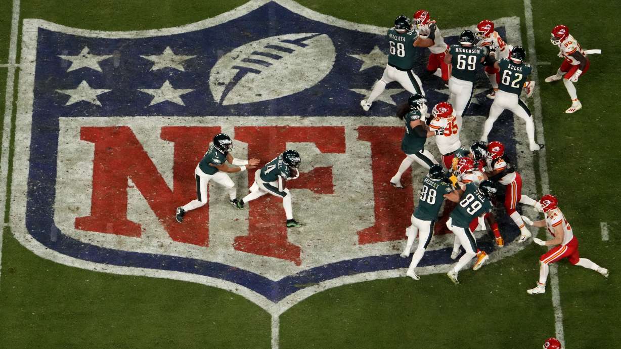 Philadelphia Eagles quarterback Jalen Hurts, left, hands off to running back Kenneth Gainwell (14) during halftime of the NFL Super Bowl 57 football game against the Kansas City Chiefs, Sunday, Feb. 12, 2023, in Glendale, Ariz.