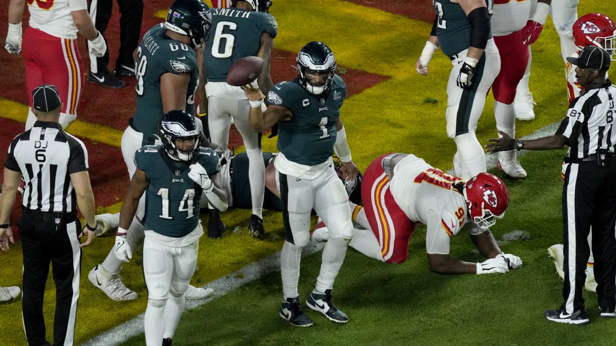 Philadelphia Eagles quarterback Jalen Hurts (1) tosses the ball after his touchdown against the Kansas City Chiefs during the second half of the NFL Super Bowl 57 football game, Sunday, Feb. 12, 2023, in Glendale, Ariz.