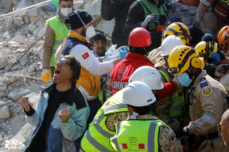 A son of a Turkish woman Saadet Sendag reacts as his mother is rescued after 177 hours, at the site of a collapsed building in the aftermath of a deadly earthquake in Hatay, Turkey Monday.