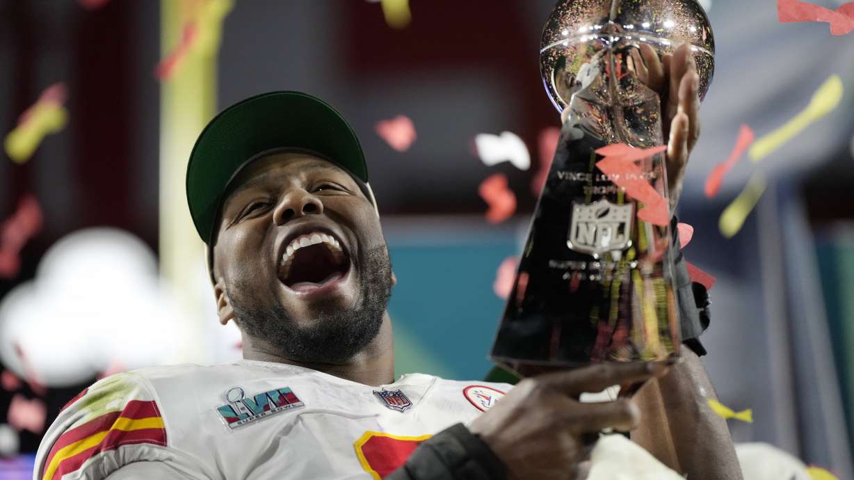Kansas City Chiefs defensive end Carlos Dunlap celebrates with the Vince Lombardi Trophy after the NFL Super Bowl 57 football game, Sunday, Feb. 12, 2023, in Glendale, Ariz. The Kansas City Chiefs defeated the Philadelphia Eagles 38-35.