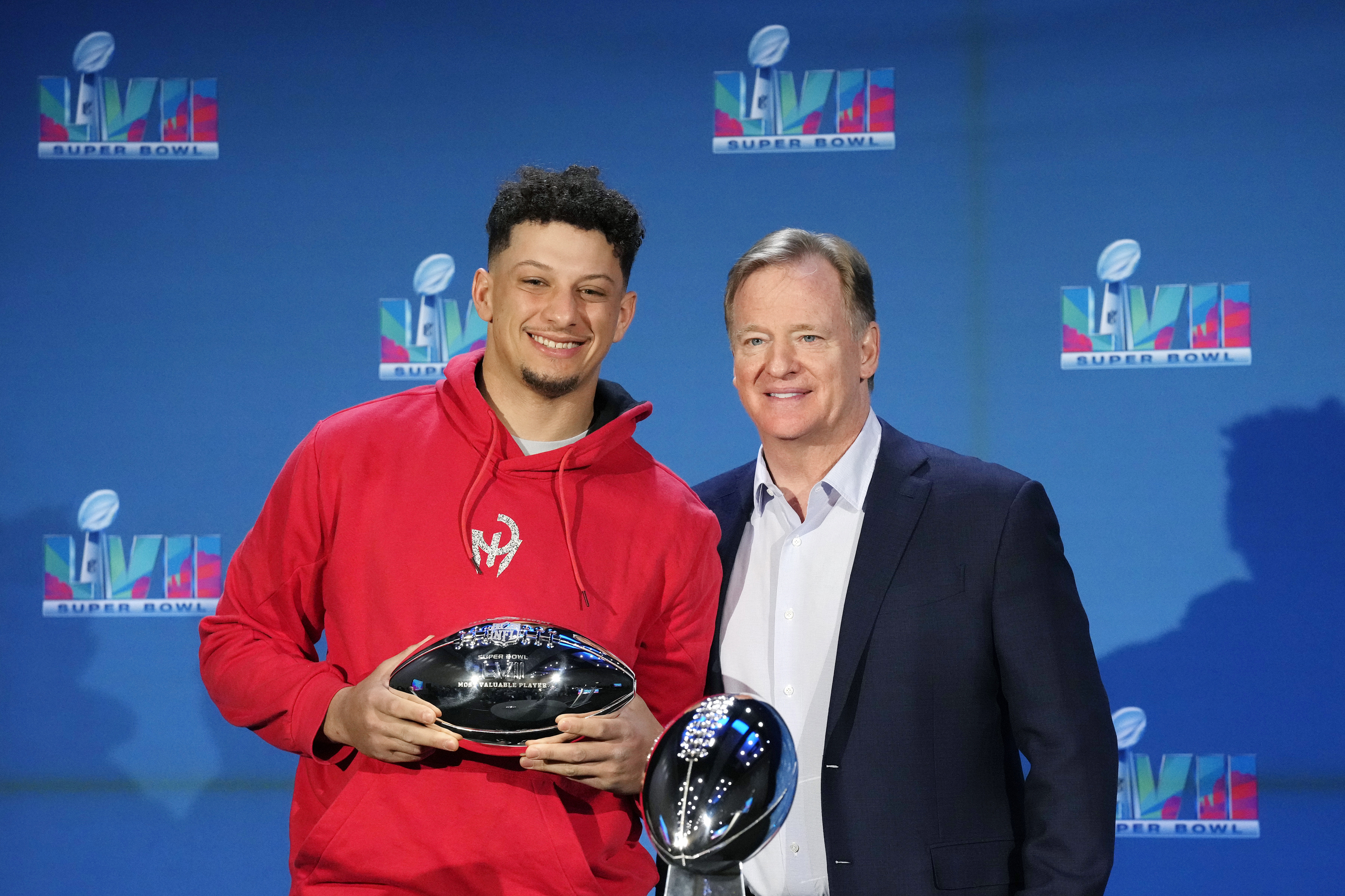 Kansas City Chiefs quarterback Patrick Mahomes, left, holds up the Super Bowl MVP Trophy as he stands next to NFL Commissioner Roger Goodell during an NFL Super Bowl football news conference in Phoenix, Monday, Feb. 13, 2023. The Chiefs defeated the Philadelphia Eagles 38-35 in Super Bowl LVII. 