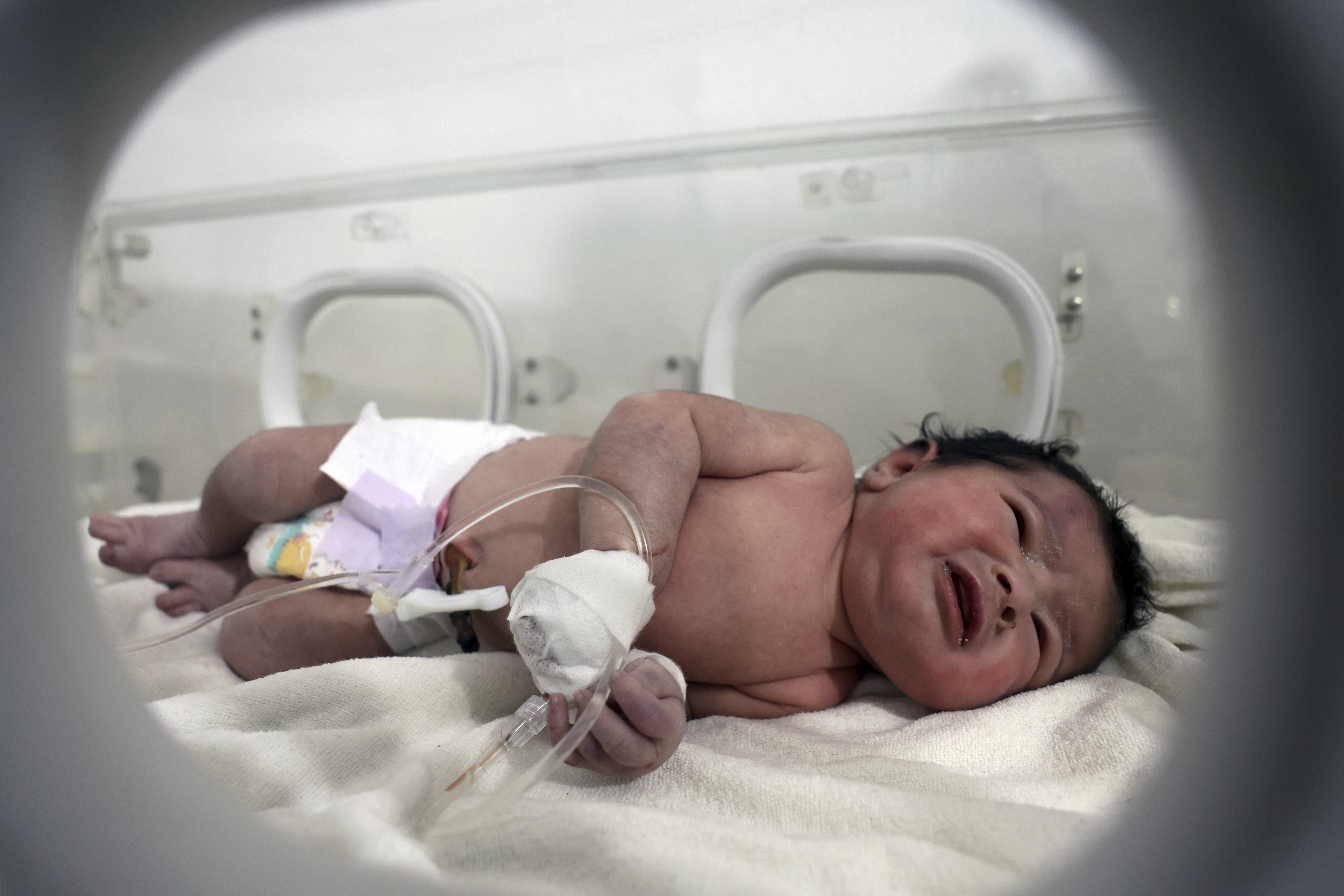 A baby girl who was born under the rubble caused by an earthquake that hit Syria and Turkey receives treatment inside an incubator at a children's hospital in Afrin, Aleppo province, Syria, Tuesday.
