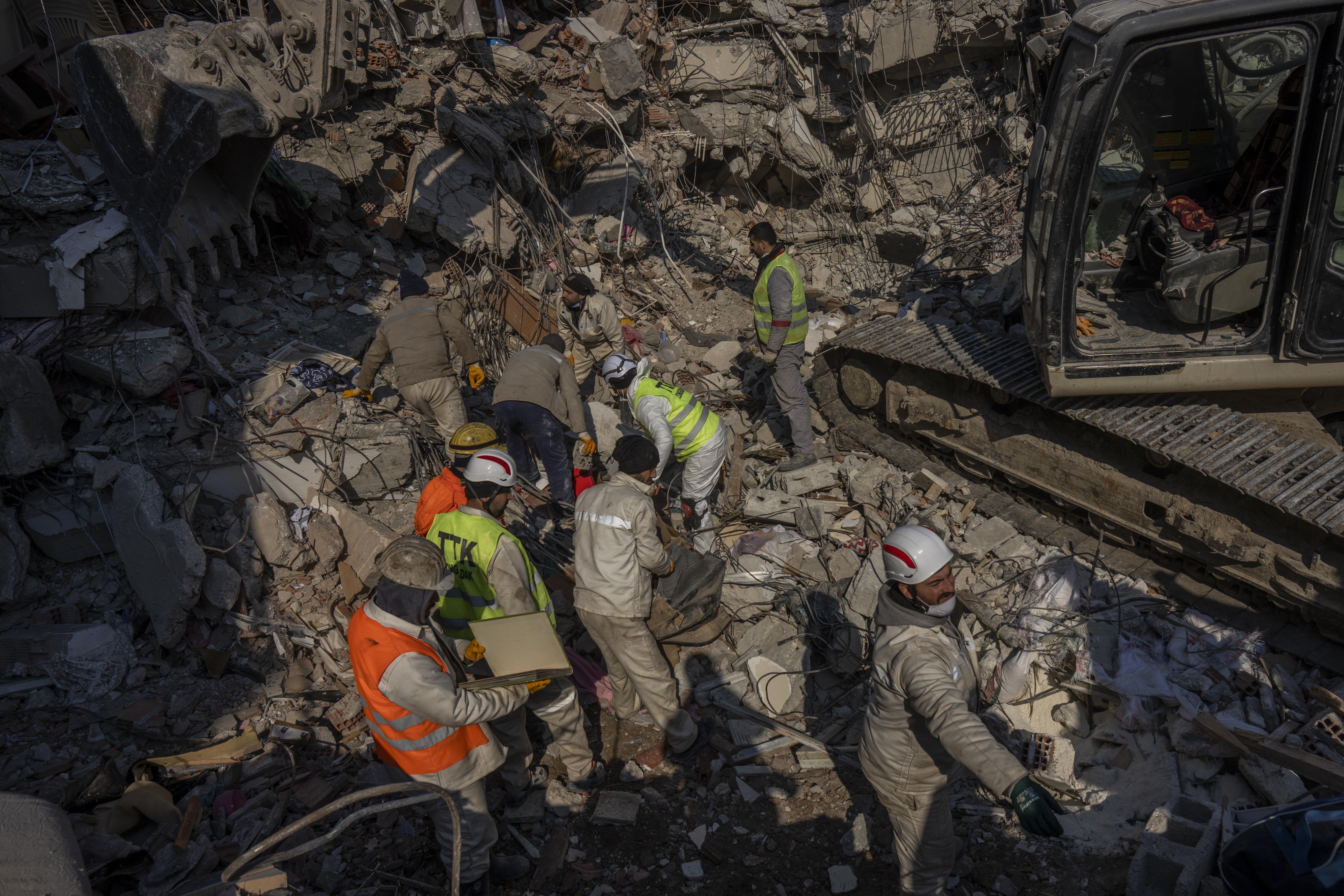 Members of a search and rescue team work on a collapsed structure after the earthquake in Antakya, southeastern Turkey, Sunday. Starting Monday, a crucial Twitter tool used by software developers to comb the platform for calls for help from earthquake victims, may be accessible only by paying a $100 monthly fee. 