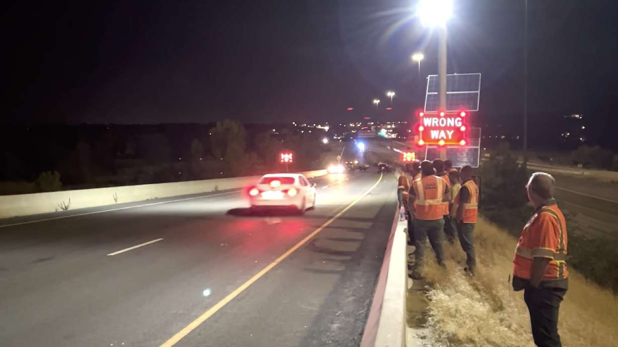 Utah Department of Transportation engineers watch as a vehicle tests a new wrong-way driver detection system at an off-ramp in Farmington in 2022. UDOT announced Monday that it is expanding the technology to other parts of the state beginning with 20 more locations this year.
