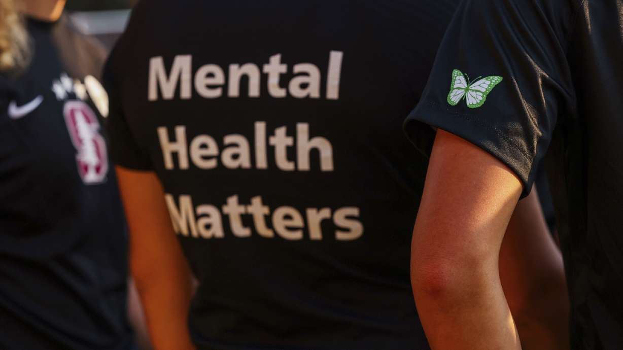 Stanford women's soccer team players wear warmup jerseys with "Mental Health Matters," Oct. 14, 2022, in Stanford, Calif. The COVID-19 pandemic took an especially harsh toll on U.S. teen girls’ mental health, with almost 60% reporting feelings of persistent sadness or hopelessness.