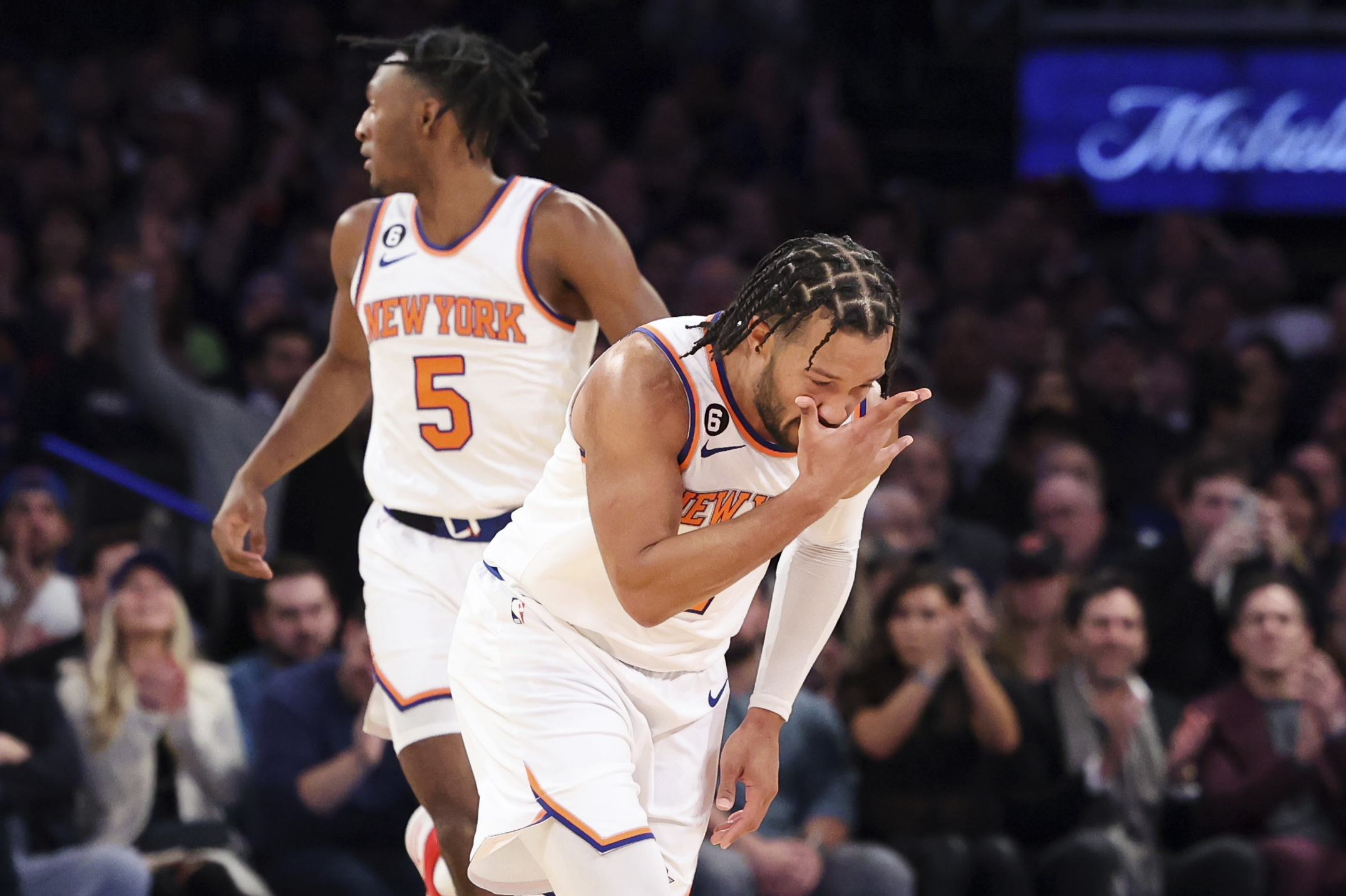 New York Knicks guard Jalen Brunson gestures after making a three point shot against the Brooklyn Nets as New York Knicks guard Immanuel Quickley (5) watches during the first half of an NBA basketball game, Monday, Feb. 13, 2023, in New York.