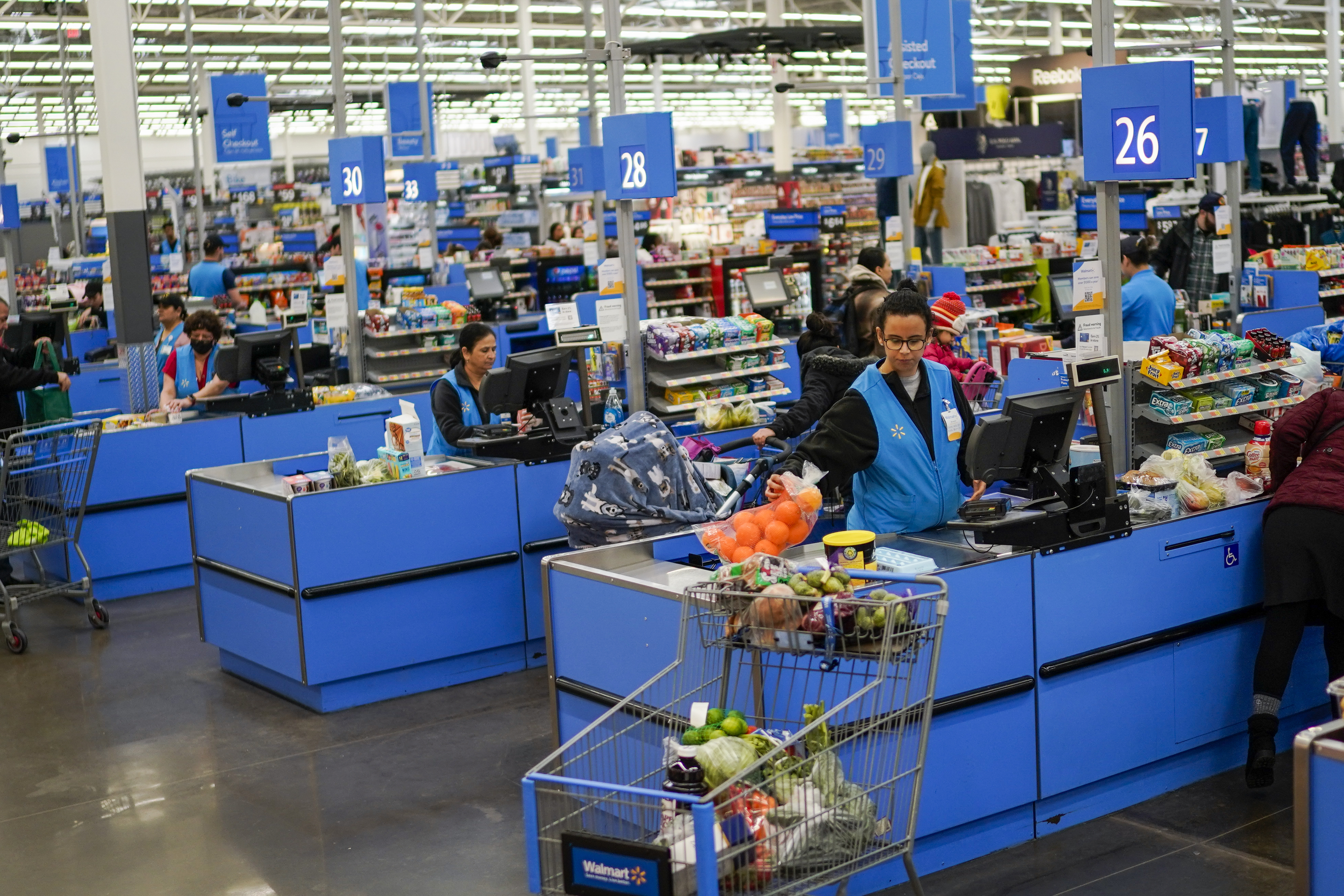Cashiers process purchases at a Walmart Supercenter in North Bergen, N.J., on Feb. 9. The government said Tuesday that consumer prices rose 6.4% in January compared with 12 months earlier, down from 6.5% in December.