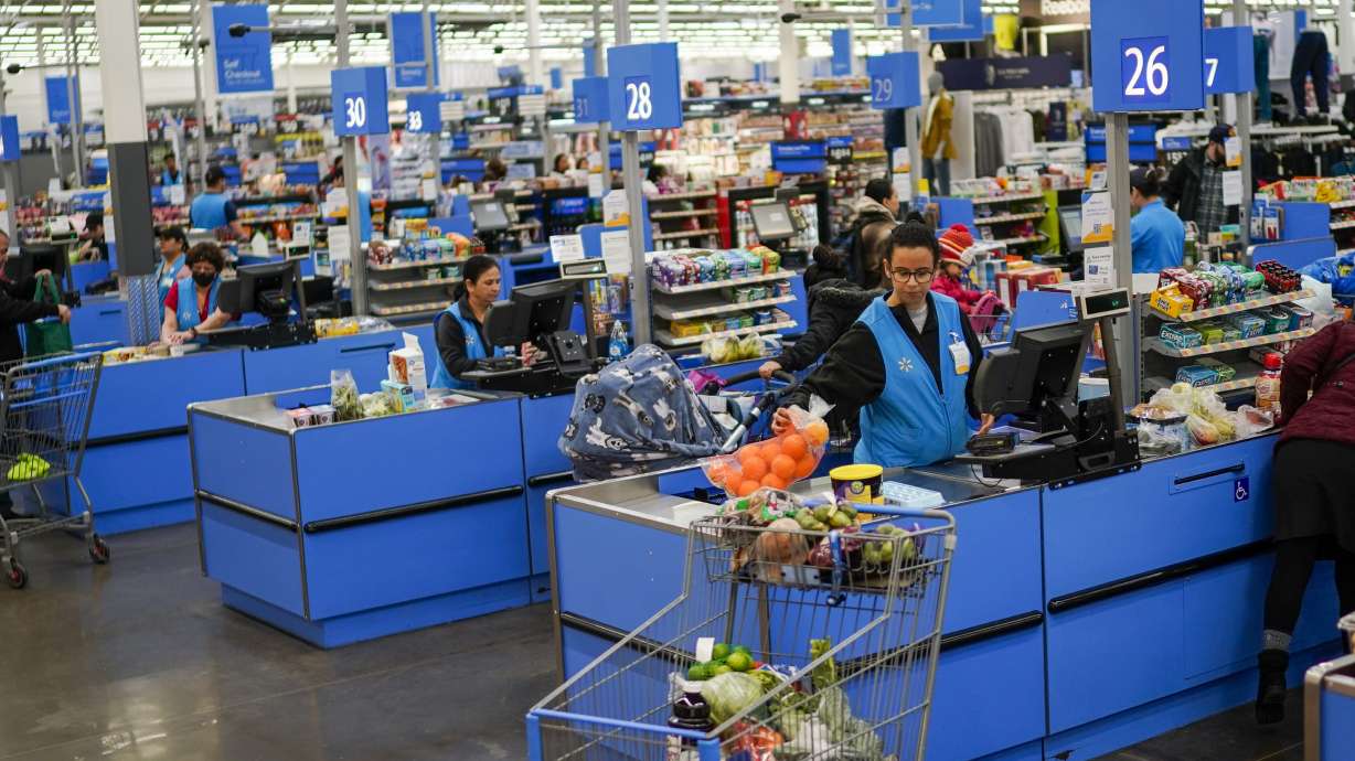 Cashiers process purchases at a Walmart Supercenter in North Bergen, N.J., on Feb. 9. The government said Tuesday that consumer prices rose 6.4% in January compared with 12 months earlier, down from 6.5% in December.