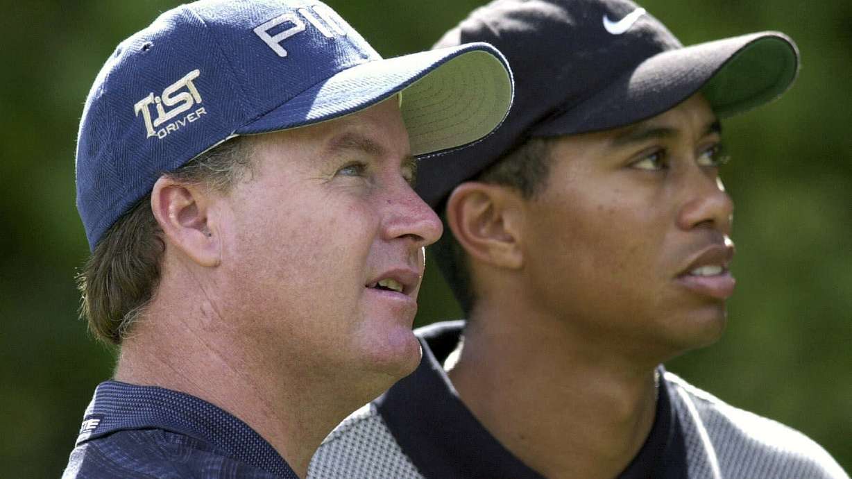 FILE - Bob May, of Las Vegas, Nev., left, along with with Tiger Woods, watches a tee shot fall on the seventh fairway during the National Car Rental Golf Classic at Walt Disney World in Lake Buena Vista, Fla., on Oct. 26, 2000. May was a journeyman from California who challenged Woods like no one else could in the summer of 2000.