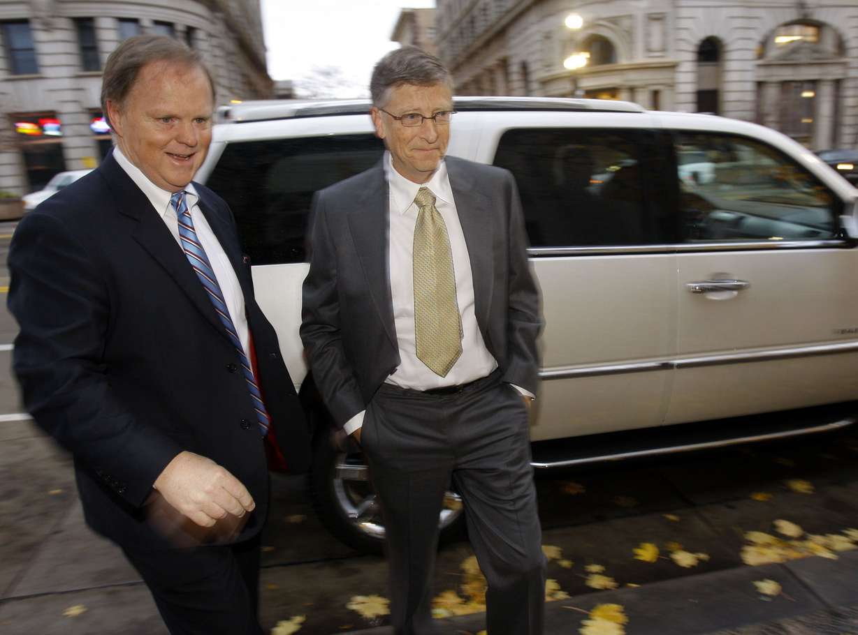 Microsoft founder Bill Gates, right, arrives at the Frank E. Moss Federal Courthouse in Salt Lake City to testify Nov. 21, 2011, in an antitrust lawsuit brought by Novell.
