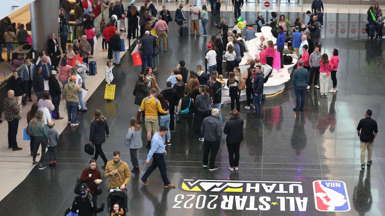 Crowds wait and exit the Salt Lake City International Airport in Salt Lake City on Wednesday. The upcoming NBA All-Star Game will bring large numbers of travelers.