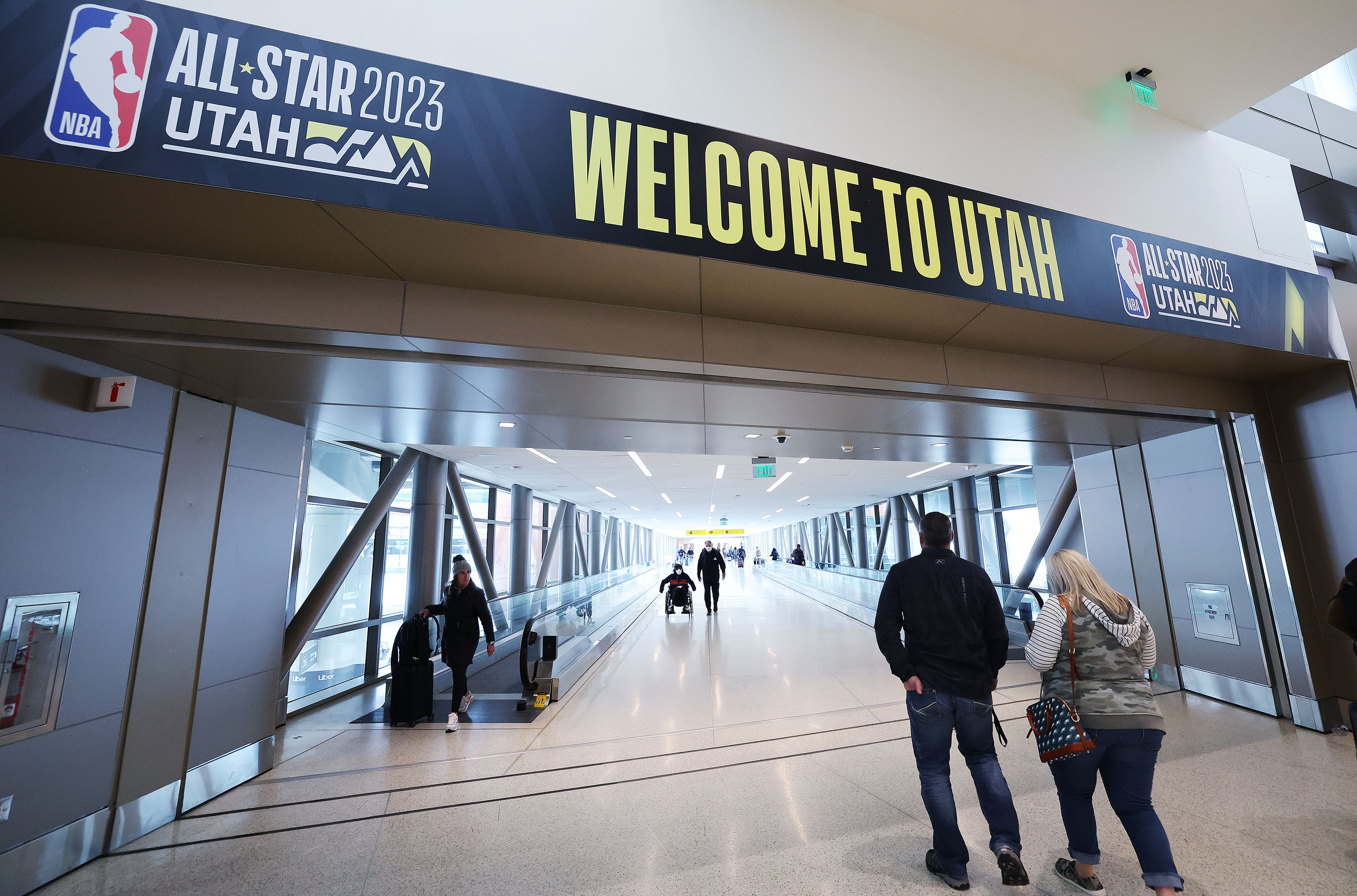 Travelers exit the Salt Lake City International Airport in Salt Lake City on Wednesday. The upcoming NBA All-Star Game will bring large numbers of travelers.