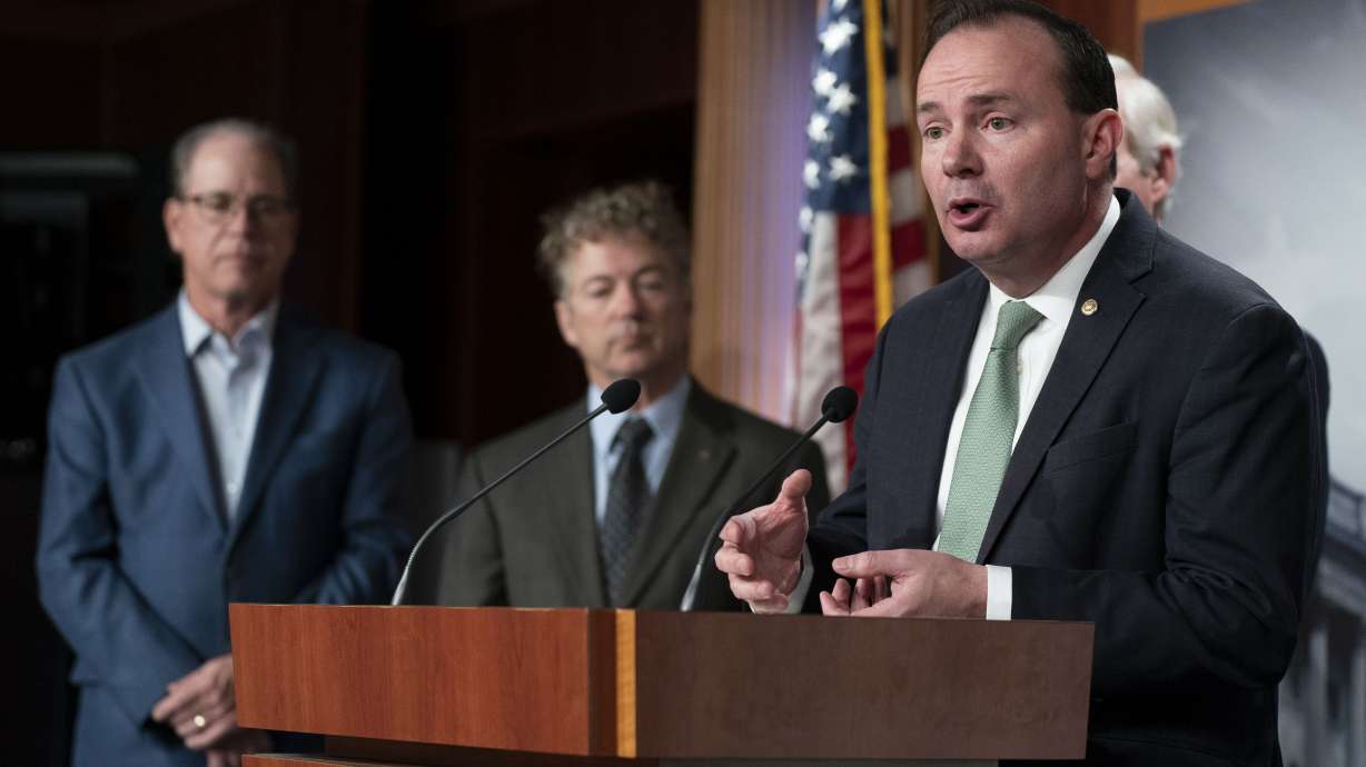 Sen. Mike Lee, R-Utah, from right, with Sens. Rand Paul, R-Ky., and Mike Braun, R-Ind., talks about the nation’s debt ceiling during a news conference on Capitol Hill in Washington, Jan. 25. Lee on Wednesday warned against "climate alarmism" in his first meeting as a member of the Senate Budget Committee.