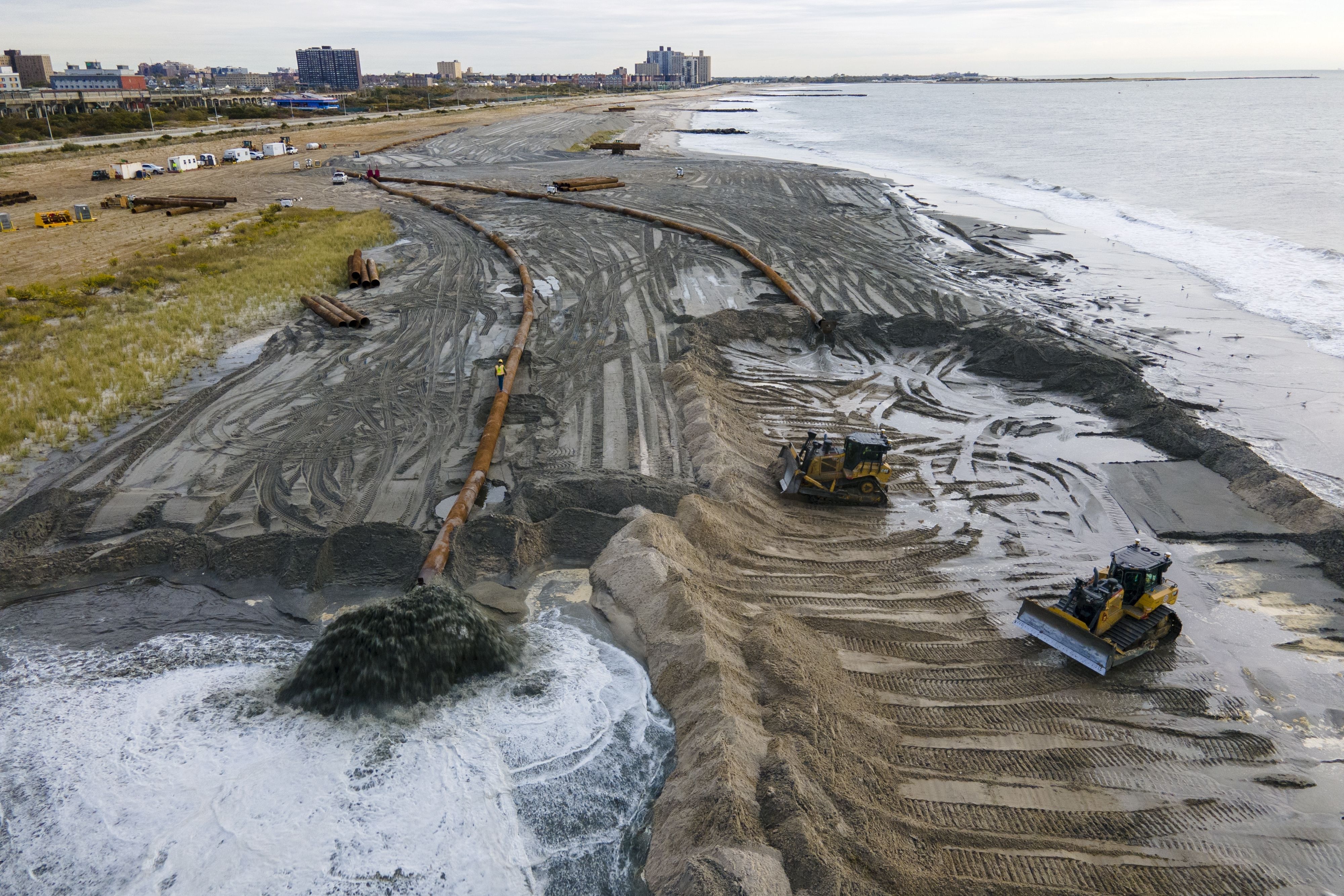 Contractors for the U.S. Army Corps of Engineers pump sand from the ocean floor onto a beach in New York City on Oct. 18, 2022. U.N. Secretary-General Antonio Guterres warned Tuesday that even if global warming is “miraculously” limited to 2.7 degrees Fahrenheit, there will still be a sizable sea level rise.