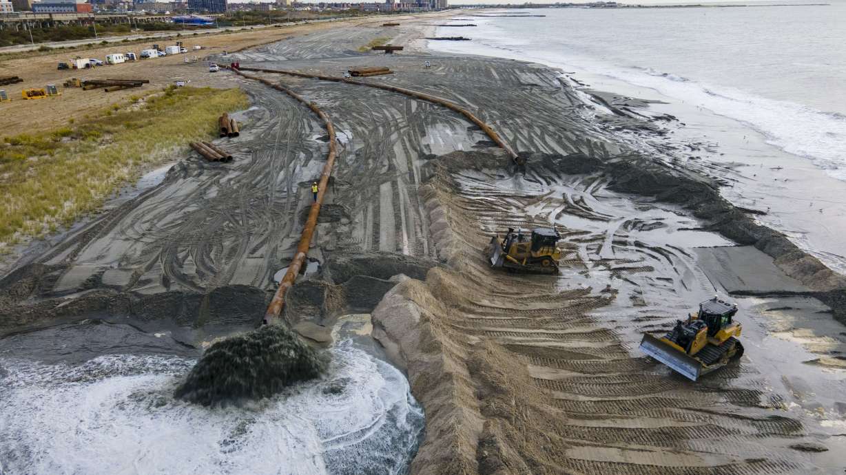 Contractors for the U.S. Army Corps of Engineers pump sand from the ocean floor onto a beach in New York City on Oct. 18, 2022. U.N. Secretary-General Antonio Guterres warned Tuesday that even if global warming is “miraculously” limited to 2.7 degrees Fahrenheit, there will still be a sizable sea level rise.