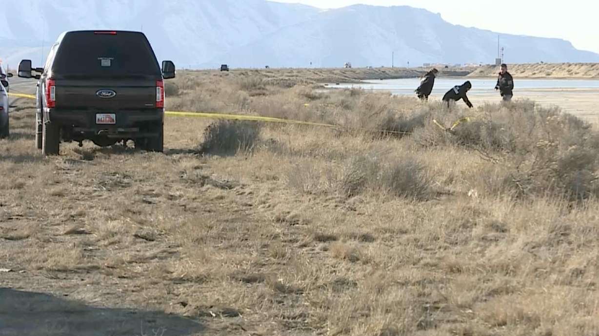 Police investigate the area where the body of a middle-aged man was found along I-80, about 2 miles west of the turnoff toward Grantsville, in Tooele County on Wednesday, Feb. 15, 2023.
