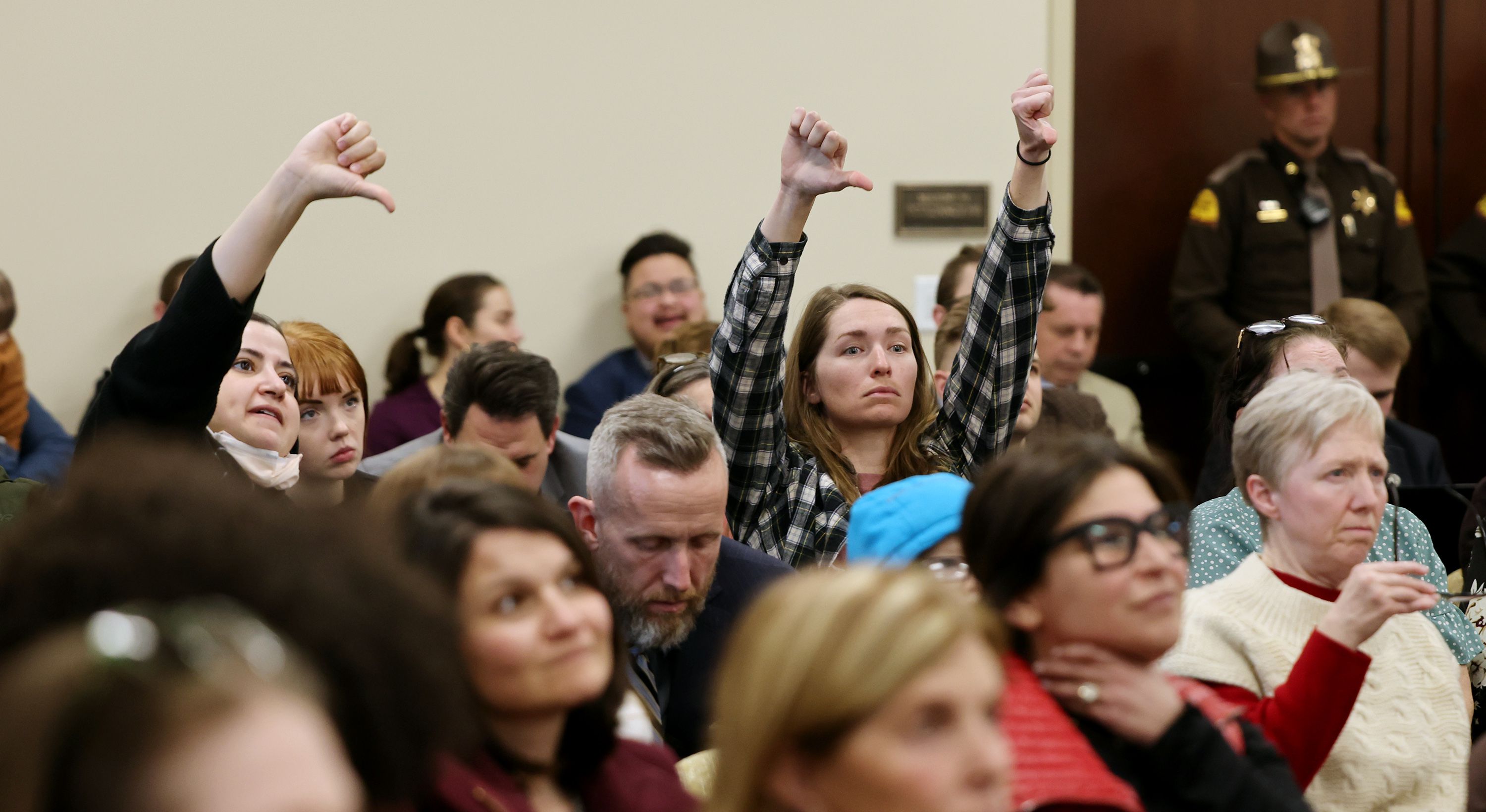 Audience members express their disapproval of comments in the House Judiciary committee as they hear HB0467 and HB297 at the Capitol on Wednesday.