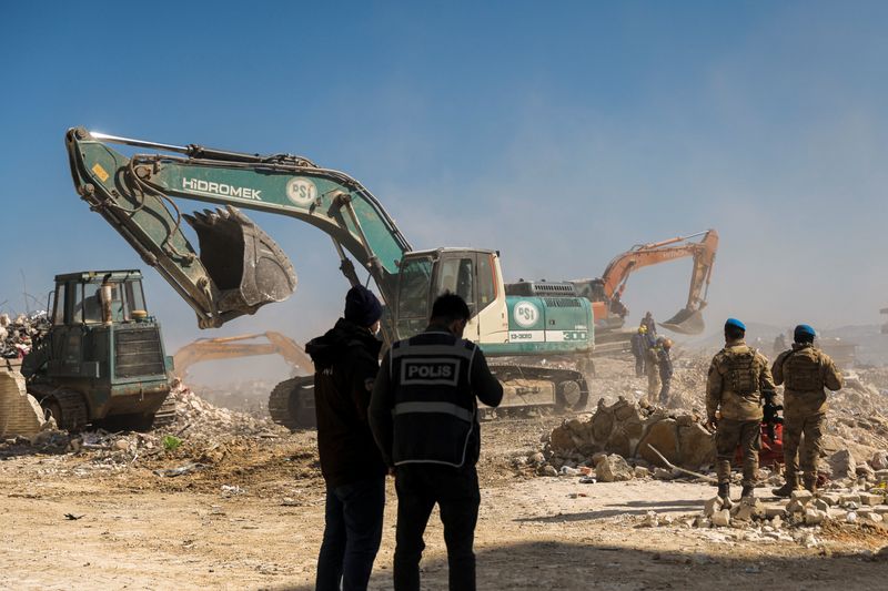 Rescuers work at the site of a destroyed high-end building as rescue operations continue, in the aftermath of a deadly earthquake in Antakya, Turkey, Thursday.