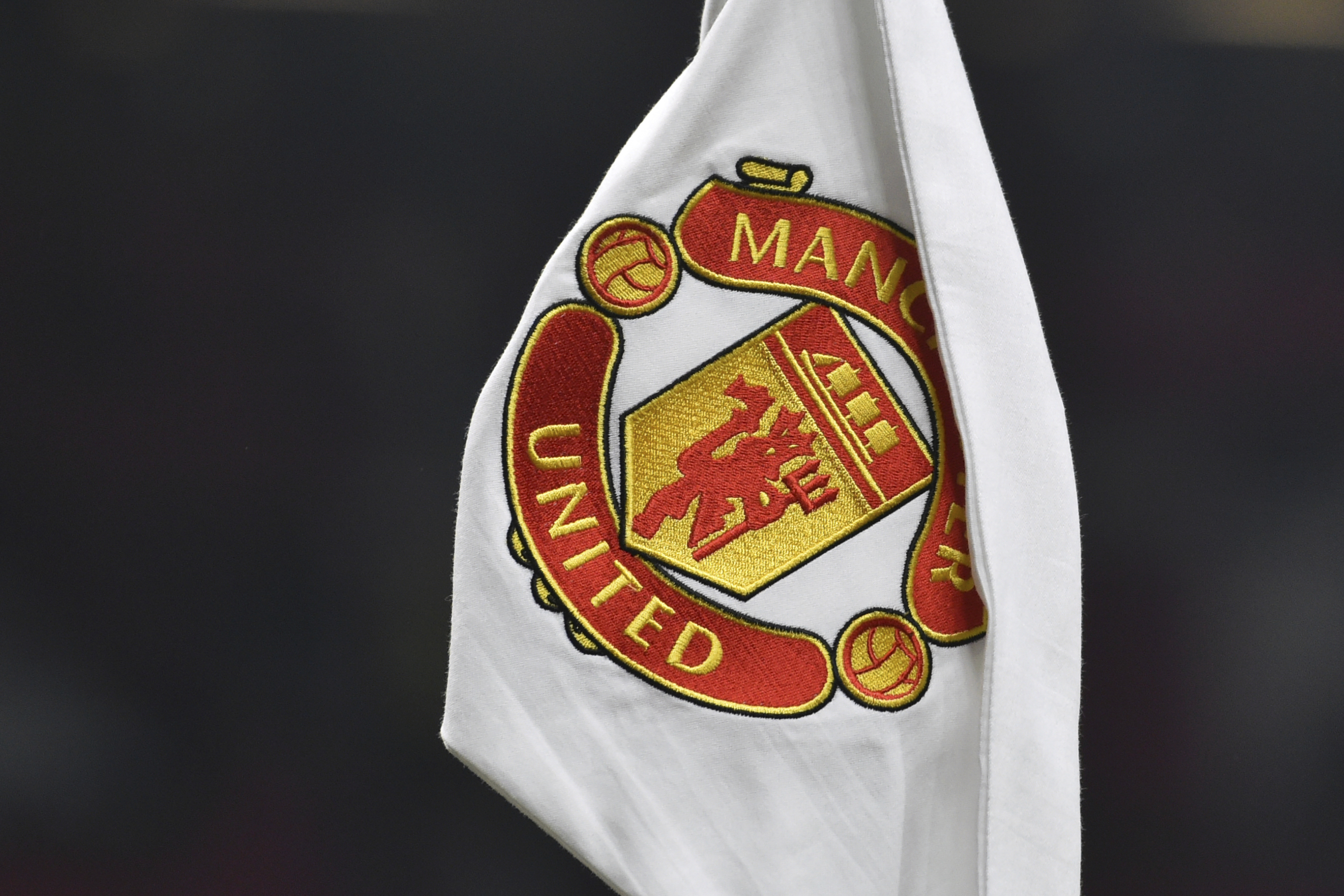 A corner flag showing the logo of Manchester United is seen ahead of the English FA Cup 4th round soccer match between Manchester United and Reading at Old Trafford in Manchester, England, Saturday, Jan. 28, 2023. 