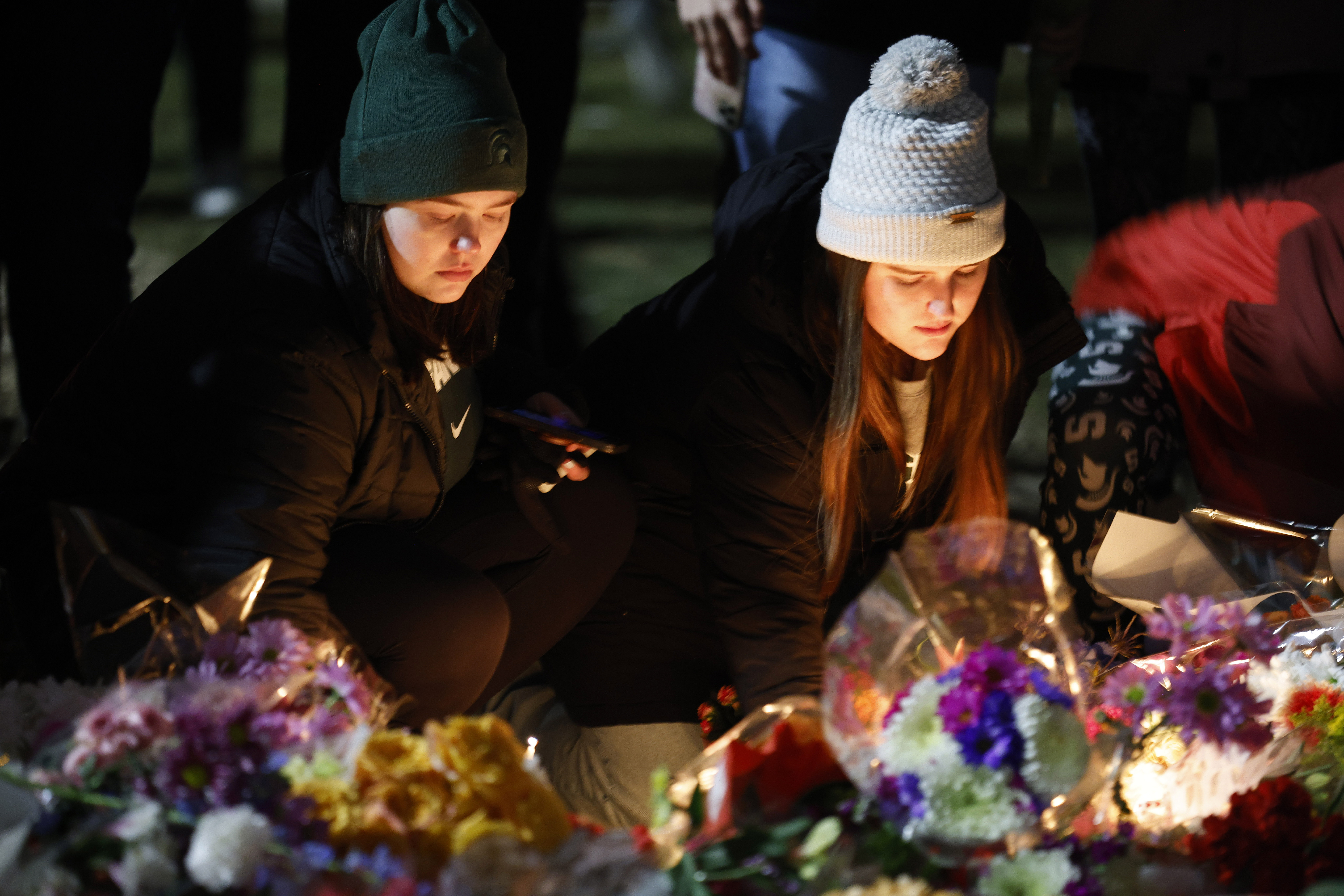 Mourners attend a vigil at The Rock on the grounds of Michigan State University in East Lansing, Mich., Wednesday. Alexandria Verner, Brian Fraser and Arielle Anderson were killed and several other students remain in critical condition after a gunman opened fire on the campus of Michigan State University Monday night. 