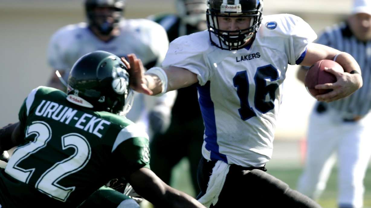 FILE - Grand Valley State quarterback Cullen Finnerty (16) holds off Northwest Missouri defender Ikechukwu Urum-Eke (22) during a Division II college football Championship game in Florence, Ala., Dec. 16, 2006. An Indiana jury has found the NCAA not liable in the death of former Grand Valley State quarterback whose widow accused the college sports governing body of failing to warn college athletes about the risks of head injuries while playing football. A Marion County jury agreed Wednesday, Feb. 15, 2023, with the NCAA’s arguments that Cullen Finnerty’s death did not result from a concussion he suffered while playing for the Michigan college or smaller blows to the head during his playing days, but from other health problems and addictions, ESPN reported.