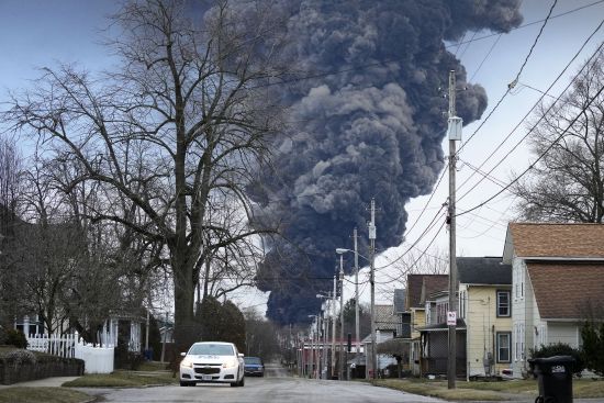 A black plume rises over East Palestine, Ohio, as a result of a controlled detonation of a portion of the derailed Norfolk Southern trains on Feb. 6.