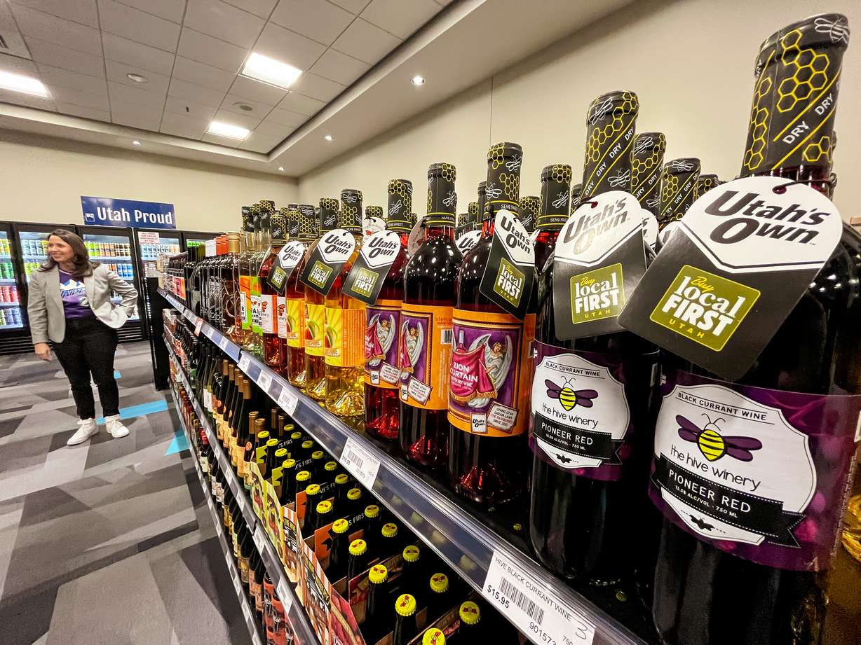 Tiffany Clason, director of the Utah Department of Alcoholic Beverage Services, speaks with members of the media in front of an aisle of Utah-made liquor products at Utah's first-ever pop-up store set up at the Salt Palace Convention Center in Salt Lake City.