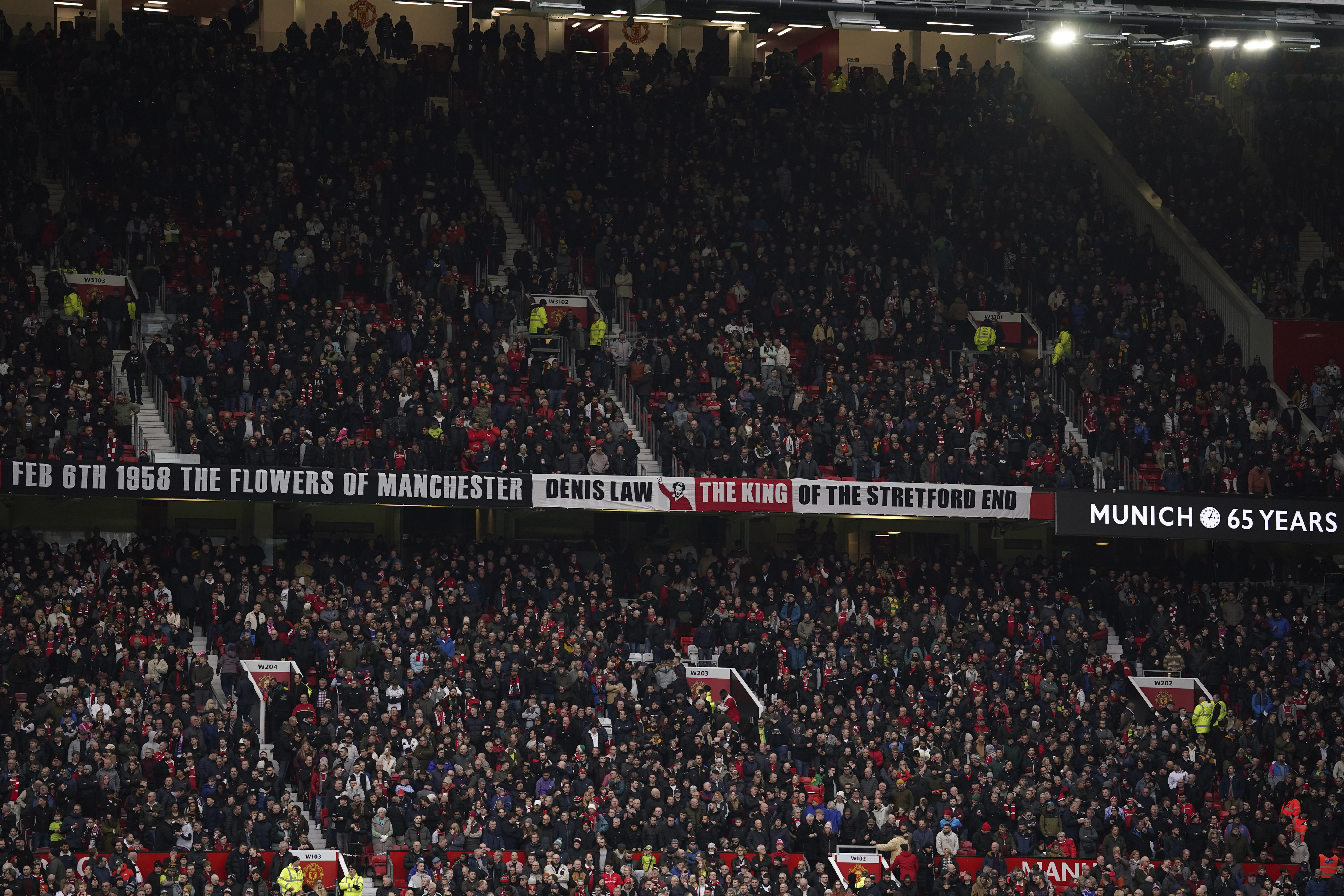 A tribute to Manchester United team - nicknamed the "Busby Babes" is displayed on screen in memory of the 65th anniversary of the Munich air disaster which saw 23 people die, prior the English Premier League soccer match between Manchester United and Crystal Palace, at the Old Trafford stadium in Manchester, England, Saturday, Feb. 4, 2023. The plane was carrying the Manchester United team - nicknamed the "Busby Babes". 