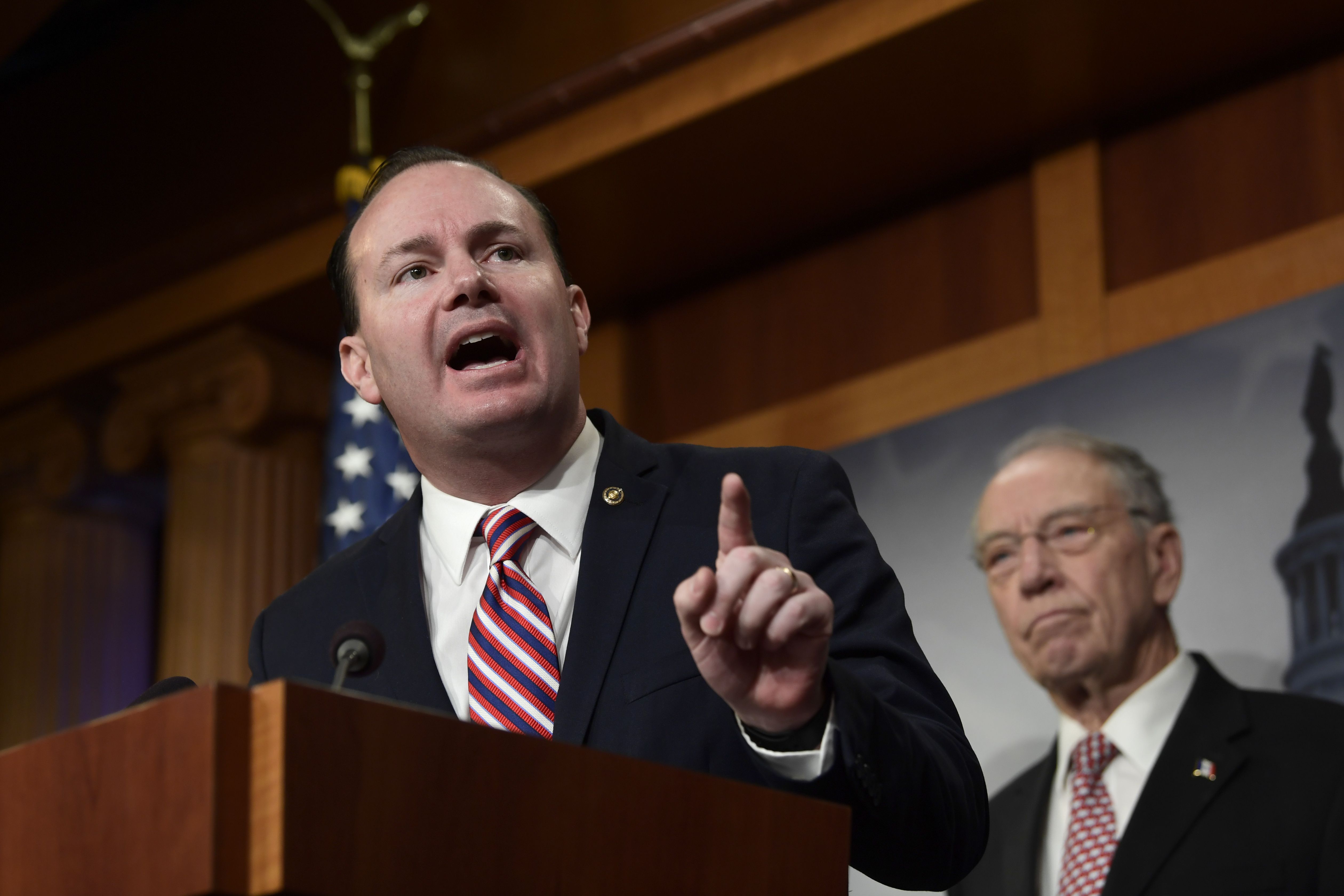 Sen. Mike Lee, R-Utah, left, speaks during a news conference on Capitol Hill in Washington on Dec. 19, 2018 as Sen. Chuck Grassley, R-Iowa, listens at right. As the United States appears on track to add $19 trillion to the national debt over the next decade, Republican senators from Utah and Iowa reintroduced a balanced budget amendment Thursday.