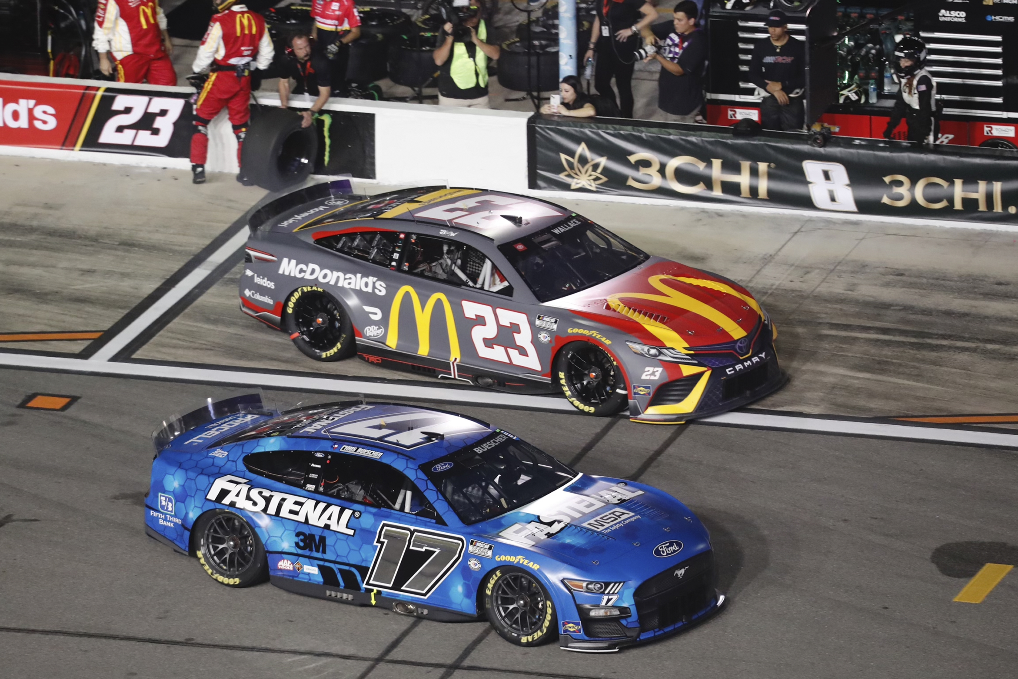 Chris Buescher (17) jumps ahead of Bubba Wallace (23) after a pit stop during the first of two qualifying auto races for the NASCAR Daytona 500 at Daytona International Speedway, Thursday, Feb. 16, 2023, in Daytona Beach, Fla. 