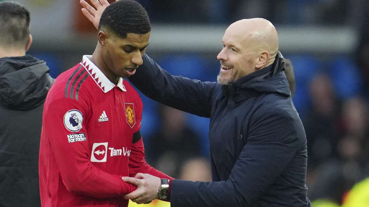 Manchester United's head coach Erik ten Hag congratulates with Marcus Rashford as he leaves the pitch during the English Premier League soccer match between Leeds United and Manchester United at Elland Road, Leeds, England, Sunday, Feb.12, 2023.