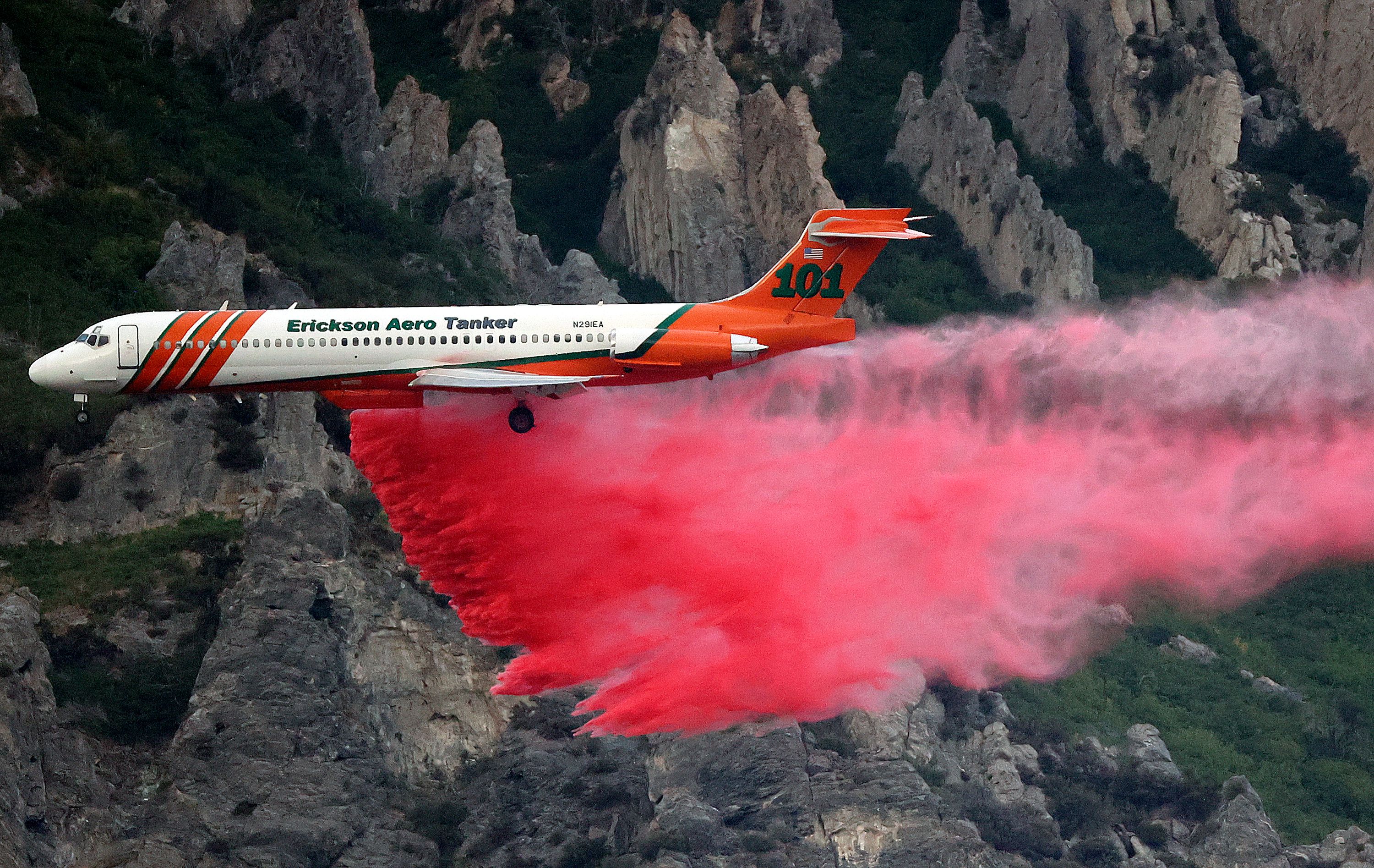 An Erickson Aero Tanker drops fire retardant over a wildfire in Springville on Aug. 1, 2022. The fire started when a man tried to burn a spider with a lighter.