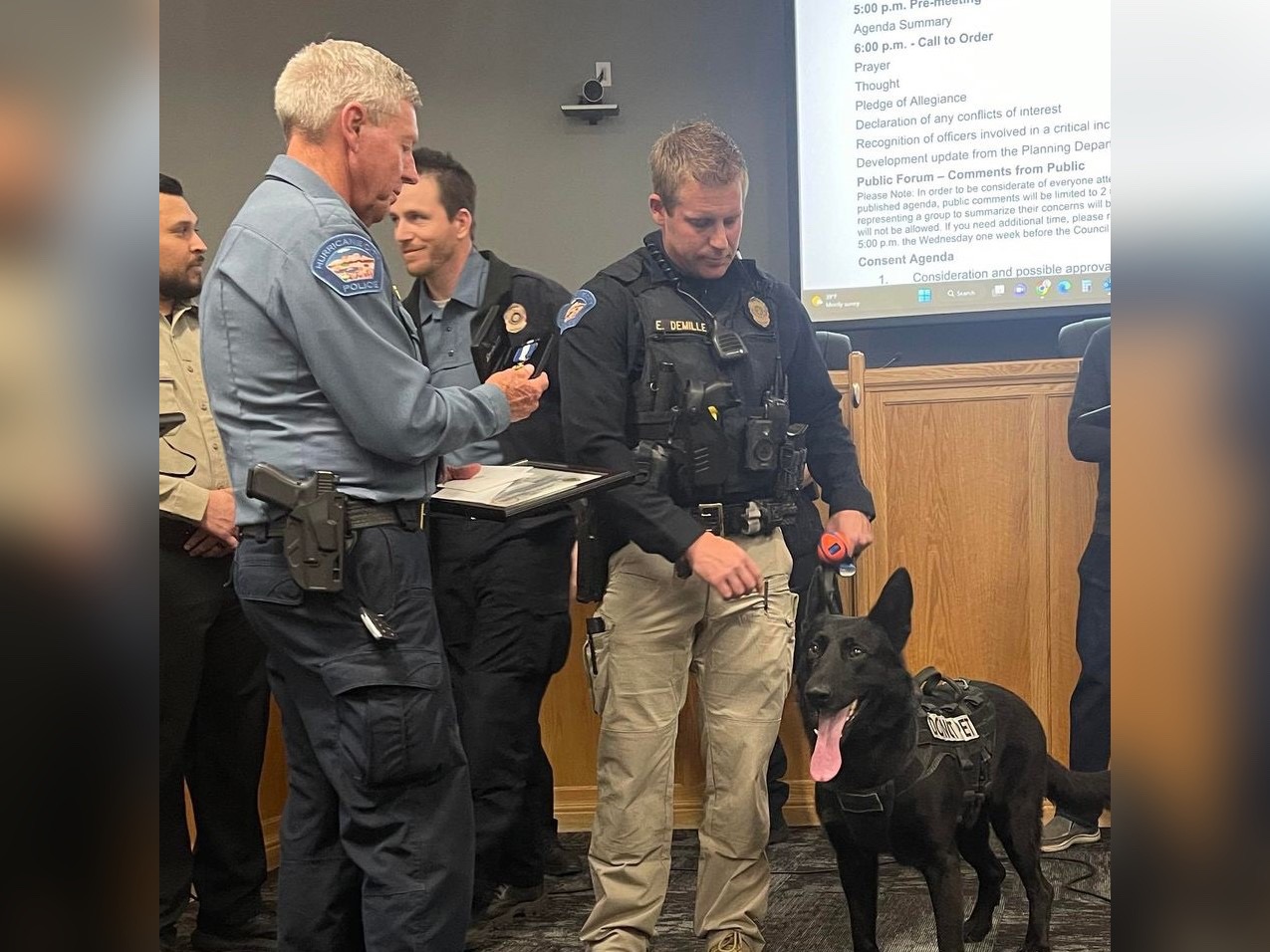 Hurricane police K-9 Riko and his handler, officer Eric DeMille, are presented with the Medal of Valor during Thursday's Hurricane City Council meeting. Riko was stabbed in the line of duty while trying to apprehended a home invader.