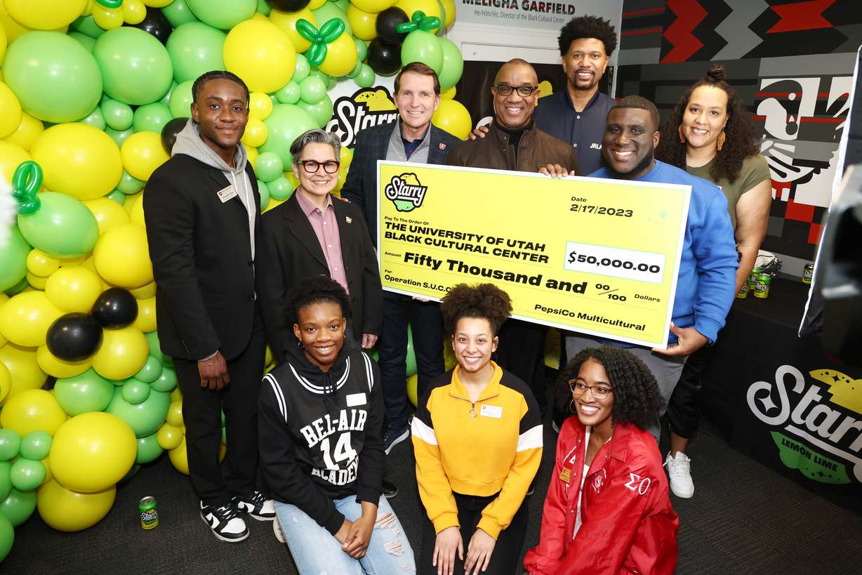 Former NBA star and ESPN analyst Jalen Rose, back, joins PepsiCo's Kirk Tanner and Kent Montgomery to donate $50,000 on behalf of STARRY to the University of Utah's Black Cultural Center at the University of Utah on February 17, 2023 in Salt Lake City, Utah.