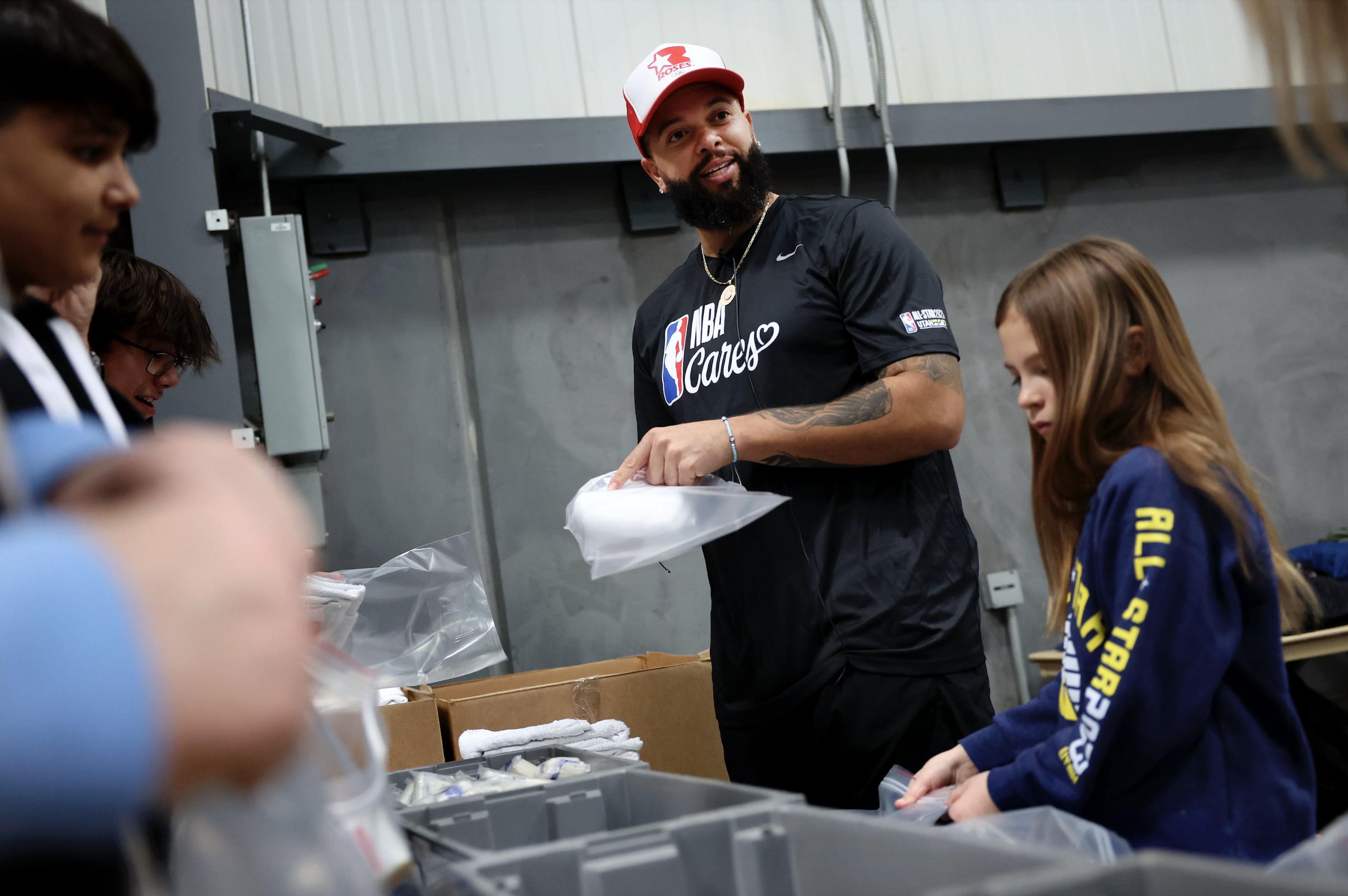 Retired NBA player Deron Williams packs up toiletries to distribute to low-income students and families at the Bishops' Central Storehouse in Salt Lake City on Friday as part of the NBA Cares All-Star Day of Service.