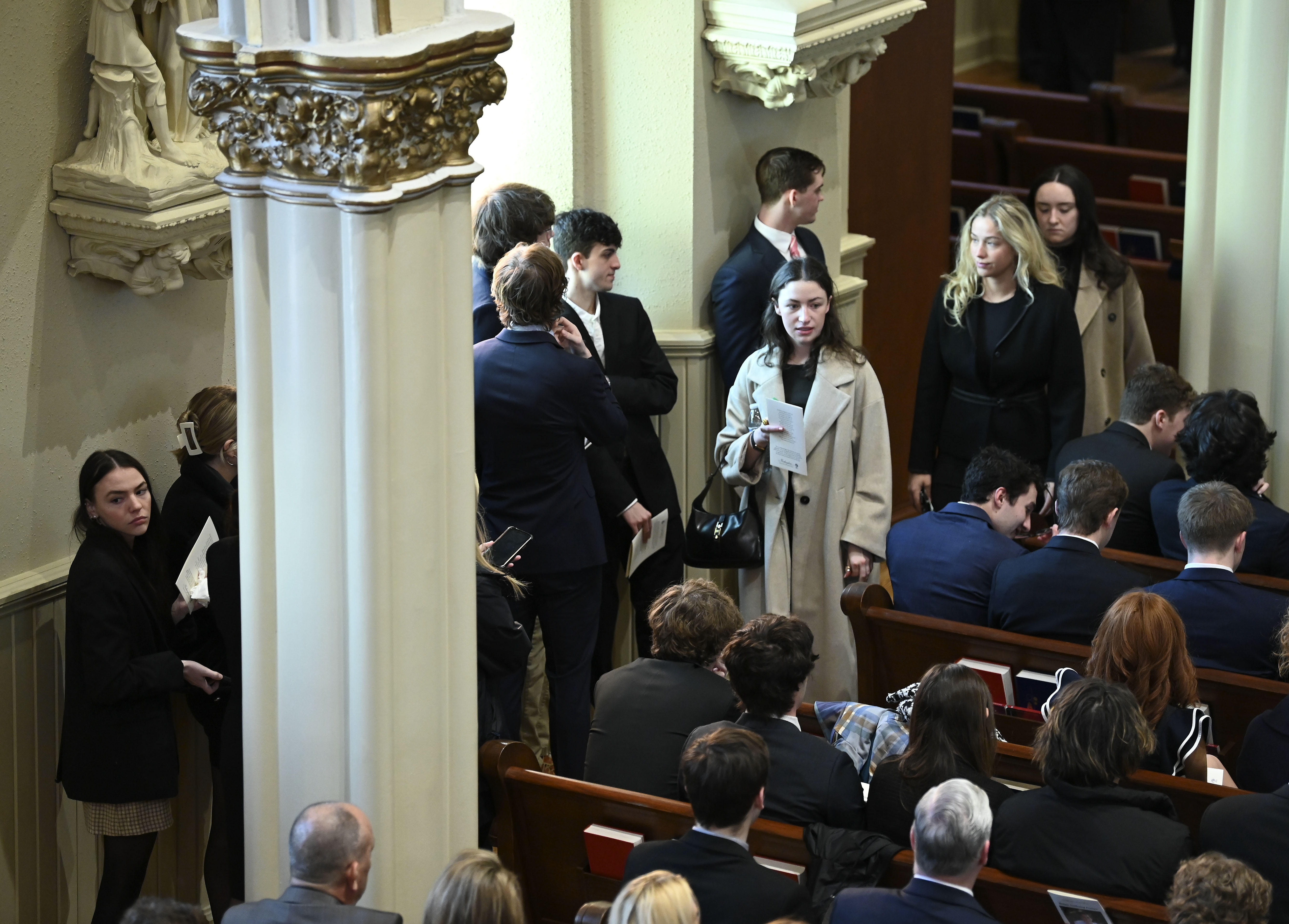 There is standing room only during family hour as family members, friends and supporters console each other during the funeral mass for Brian Fraser at St. Paul on the Lake Catholic Church, in Grosse Pointe Farms, Mich., Saturday.