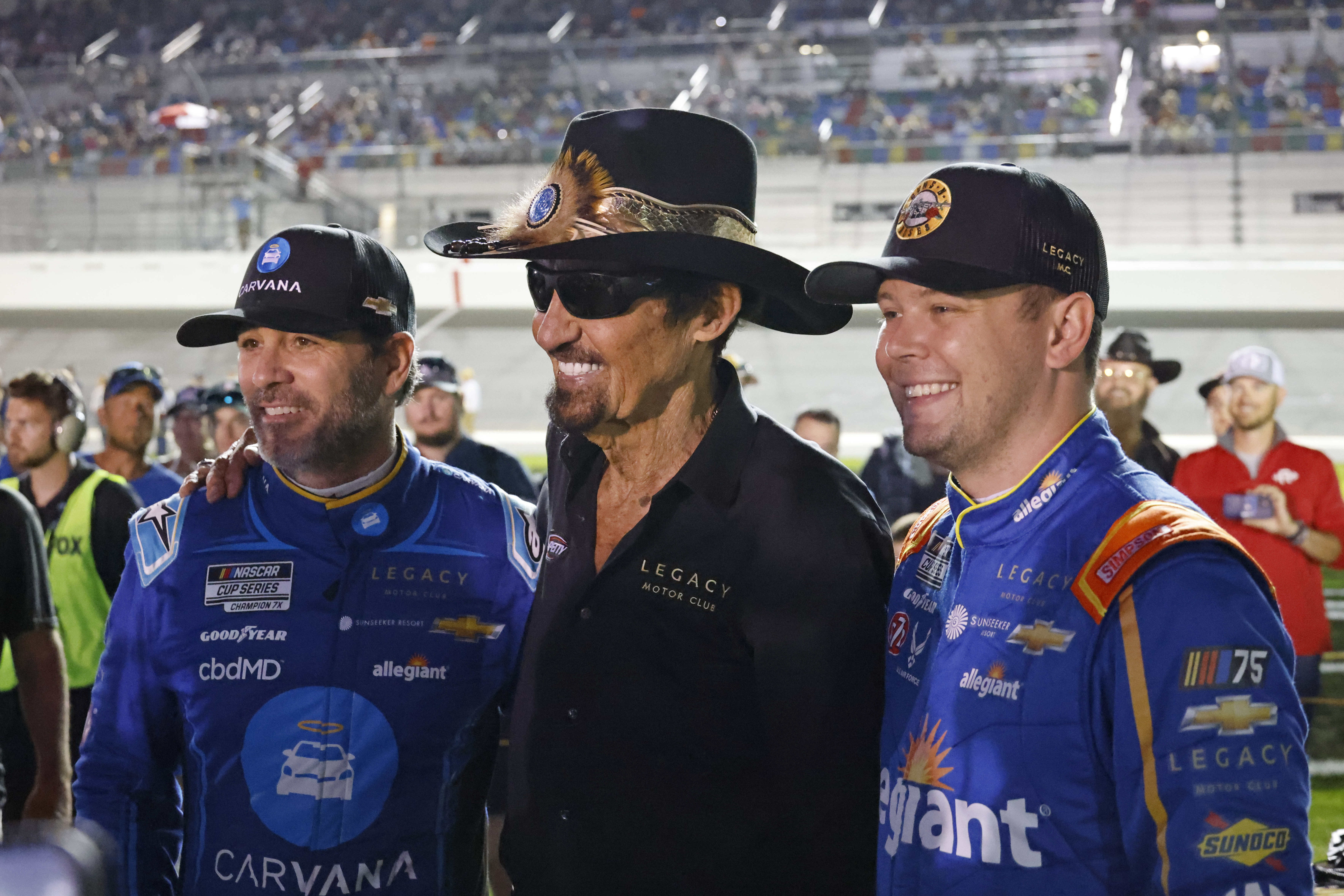 Former NASCAR driver Richard Petty, center, poses for a photo with Jimmie Johnson, left, and Erik Jones, right, before the first of two qualifying auto races for the NASCAR Daytona 500 at Daytona International Speedway, Thursday, Feb. 16, 2023, in Daytona Beach, Fla. 