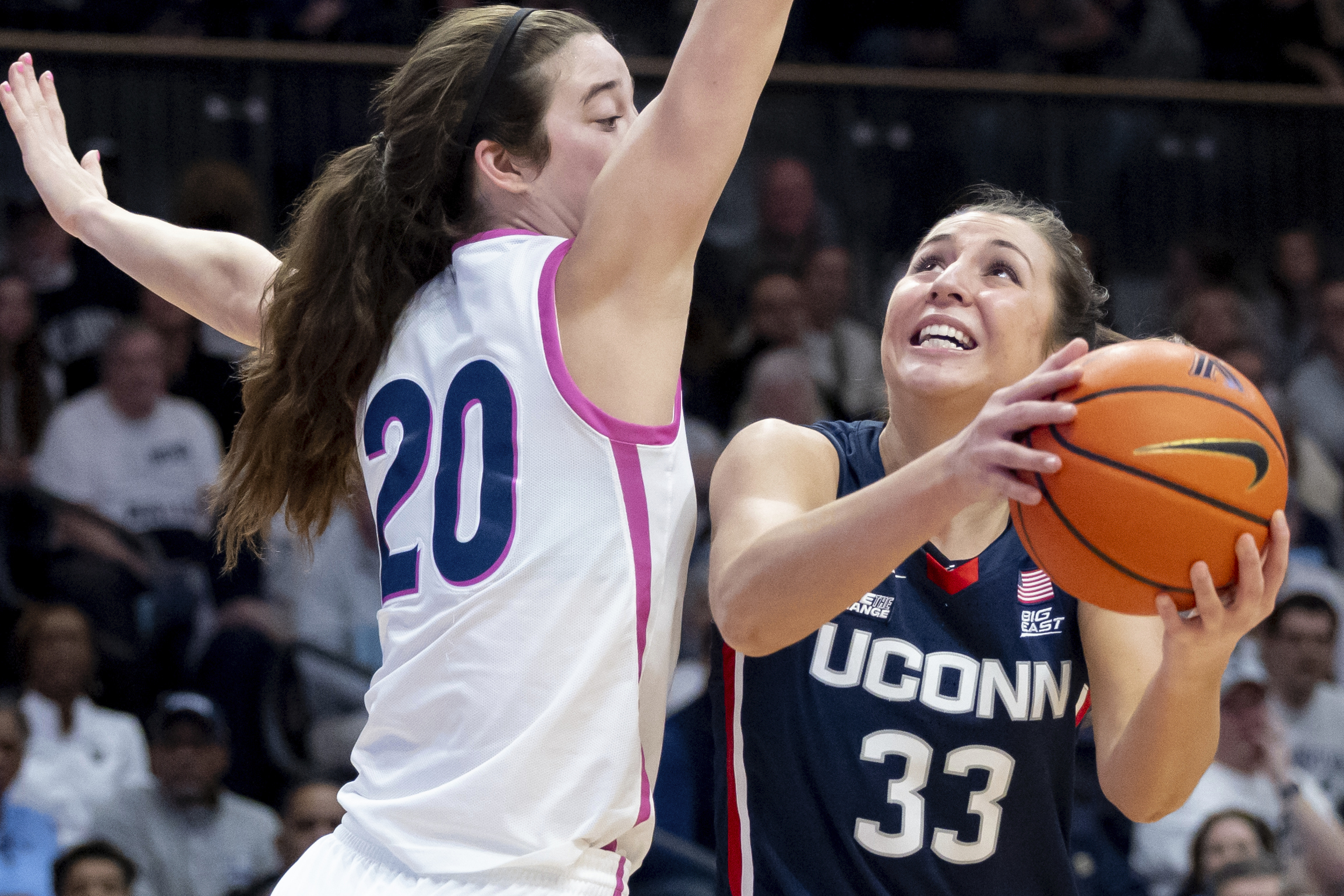 UConn guard Caroline Ducharme (33) goes to the basket past Villanova forward Maddy Siegrist (20) during the first half of an NCAA college basketball game, Saturday, Feb. 18, 2023, in Villanova, Pa. 