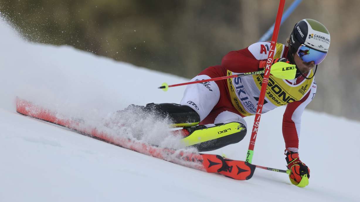 Austria's Manuel Feller speeds down the course during the men's World Championship slalom, in Courchevel, France, Sunday Feb. 19, 2023.