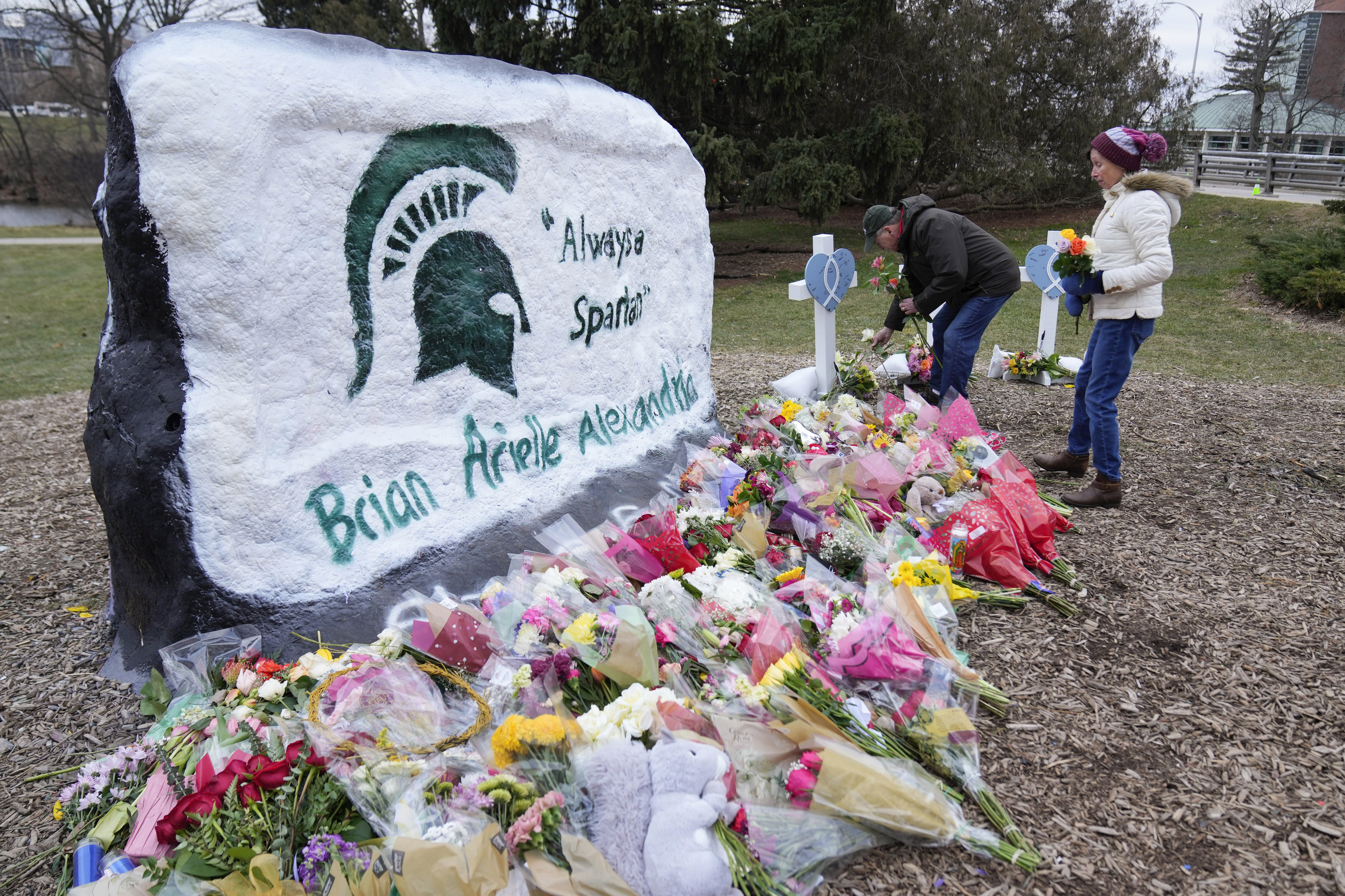 Mourners leave flowers at The Rock on the grounds of Michigan State University in East Lansing, Mich., on Feb. 15. Alexandria Verner, Brian Fraser and Arielle Anderson were killed and several other students remain in critical condition after a gunman opened fire on the campus of Michigan State University on Feb. 13.